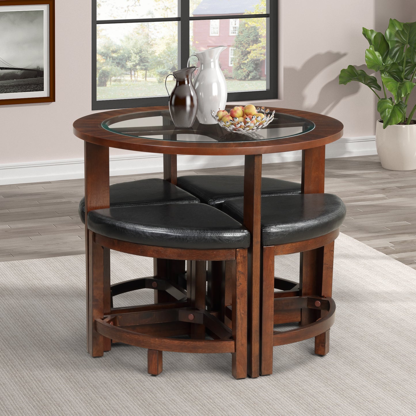 Round glass top dining table with four black faux leather stools