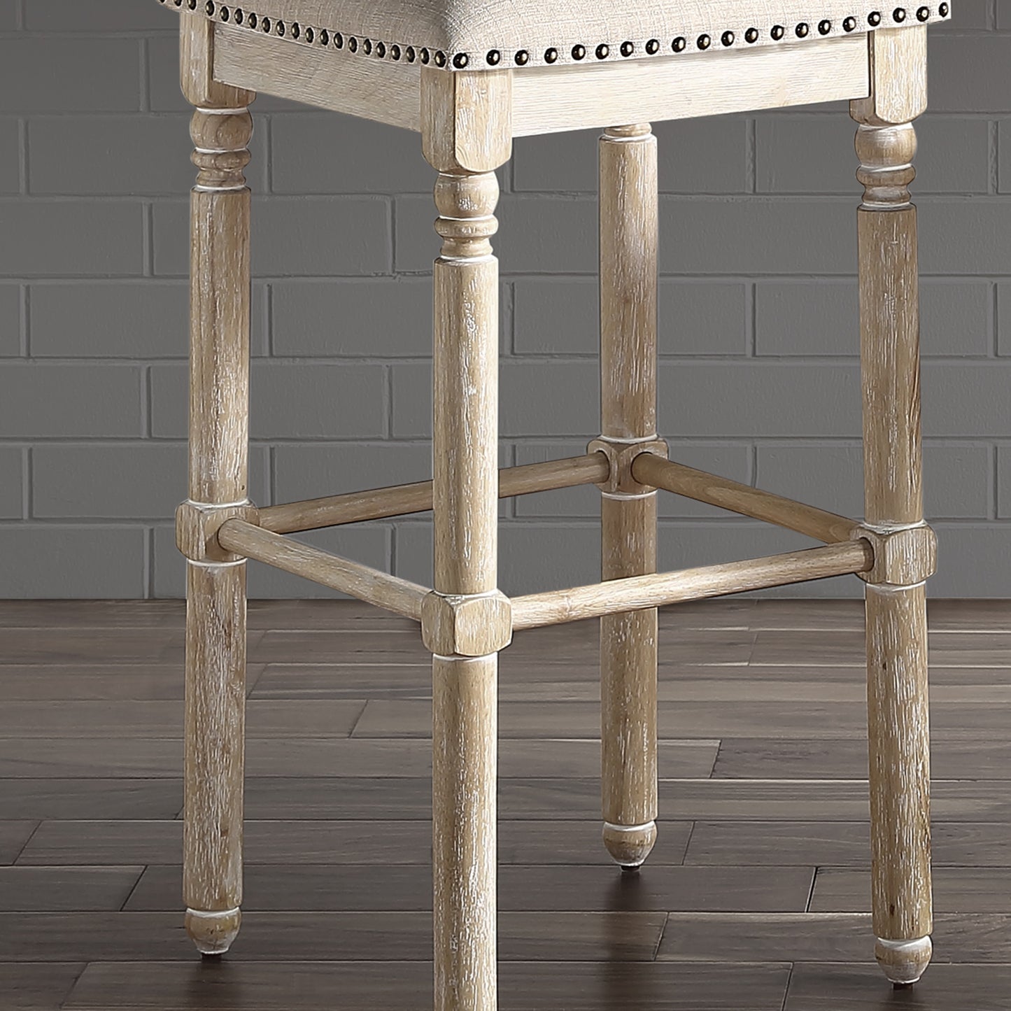 Distressed wood bar stool with neutral fabric seat and decorative nailhead trim