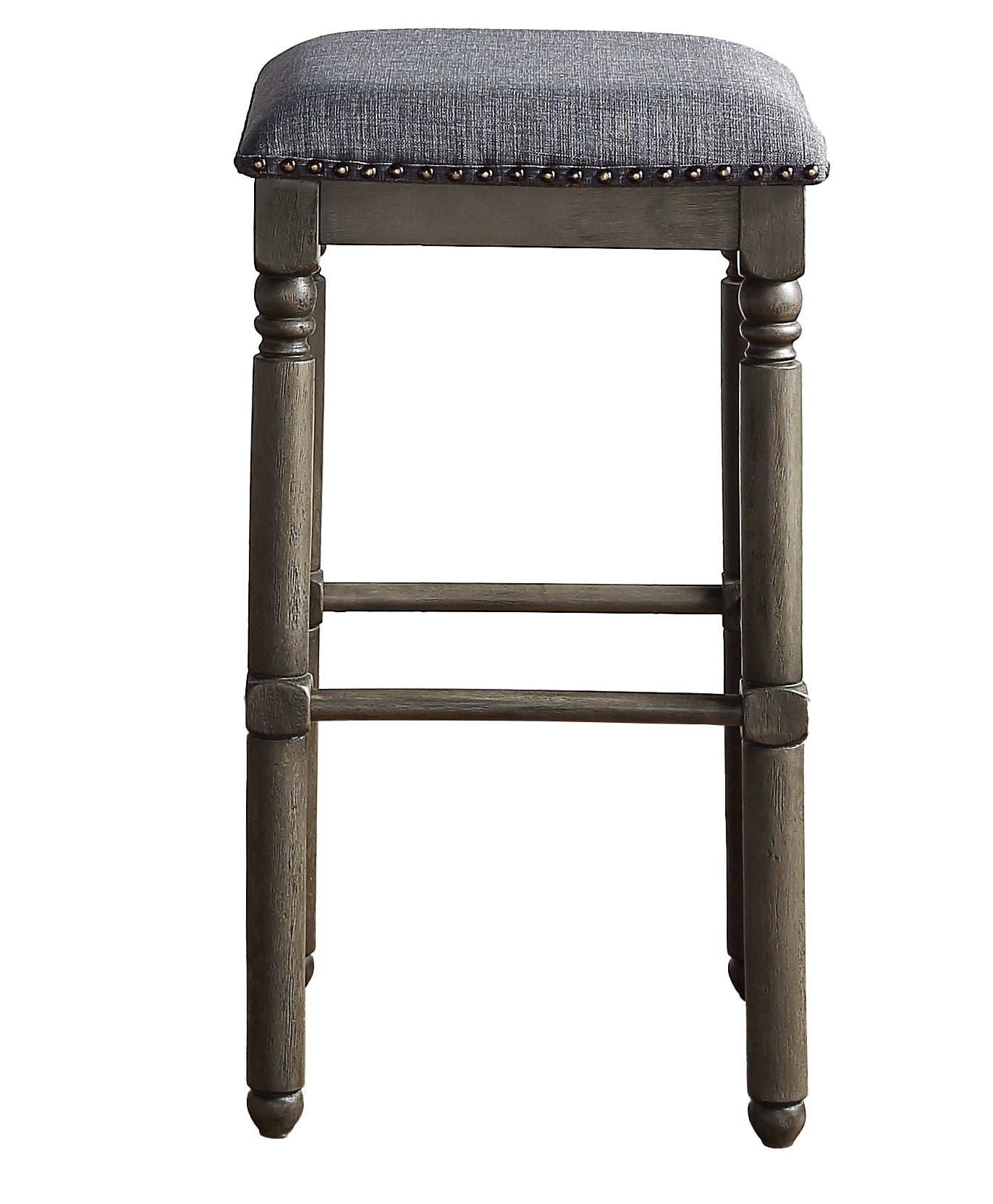 Grey upholstered bar stool with wooden legs and nailhead trim detail