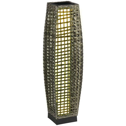 Grey rattan outdoor floor lamp with a square base and warm glowing light within