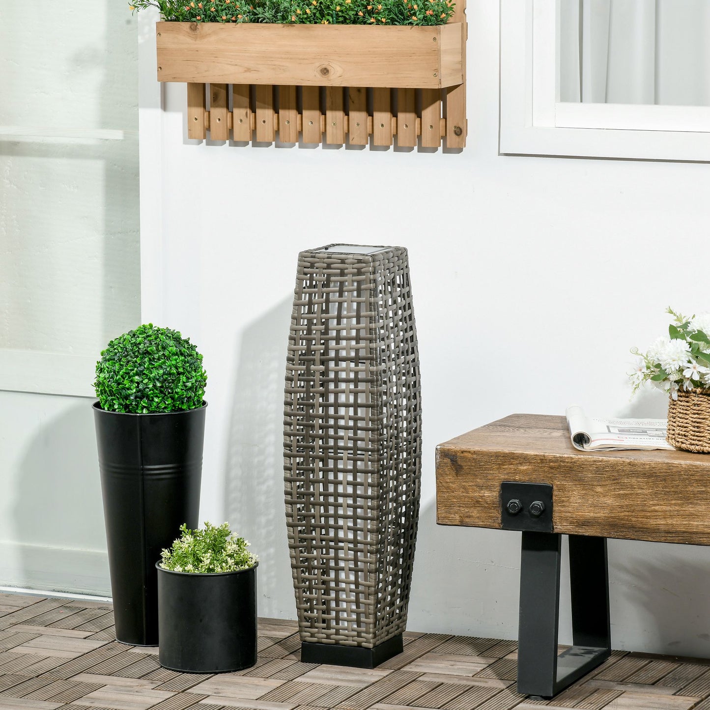 Woven grey wicker outdoor solar lantern with a square base