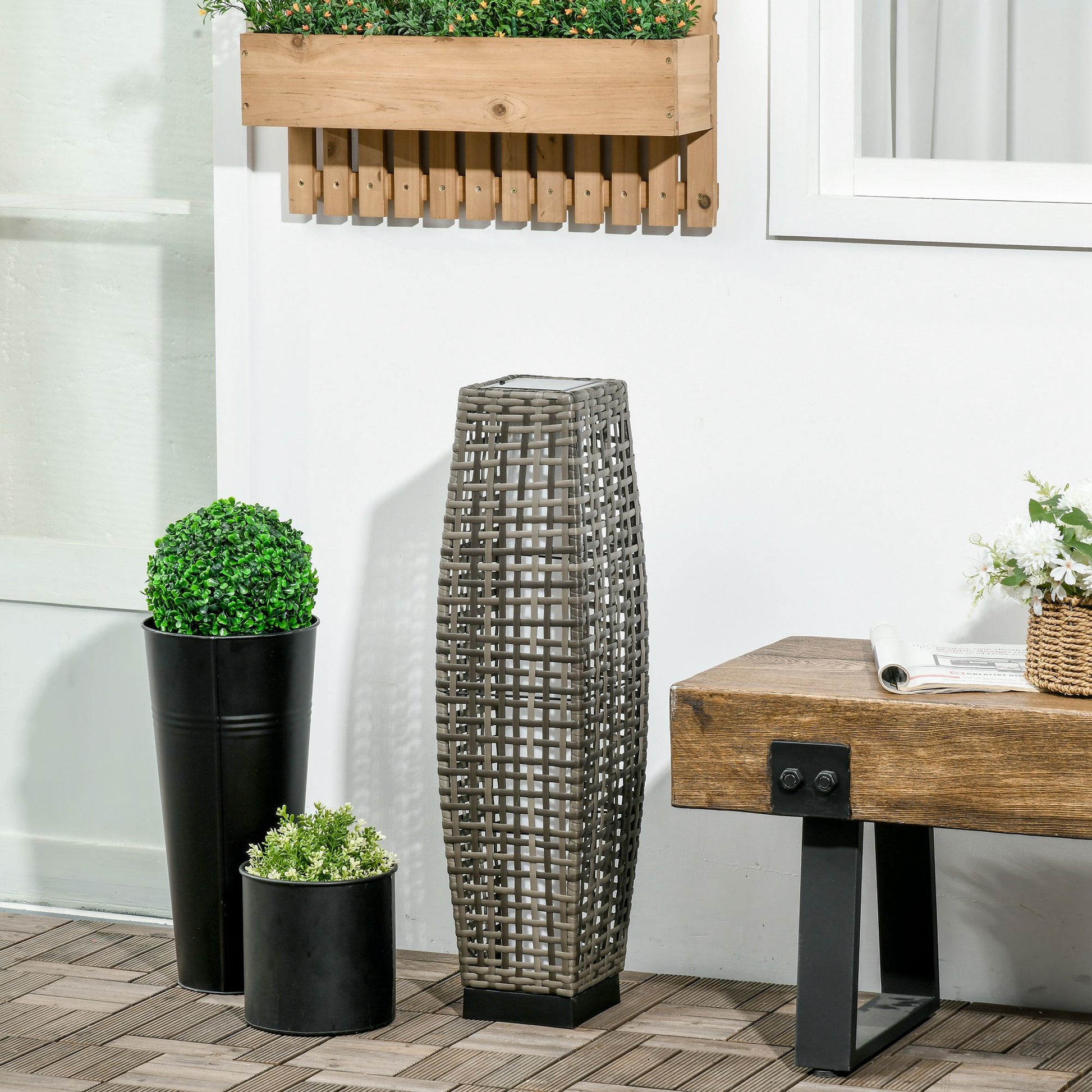 Woven grey wicker outdoor solar lantern with a square base
