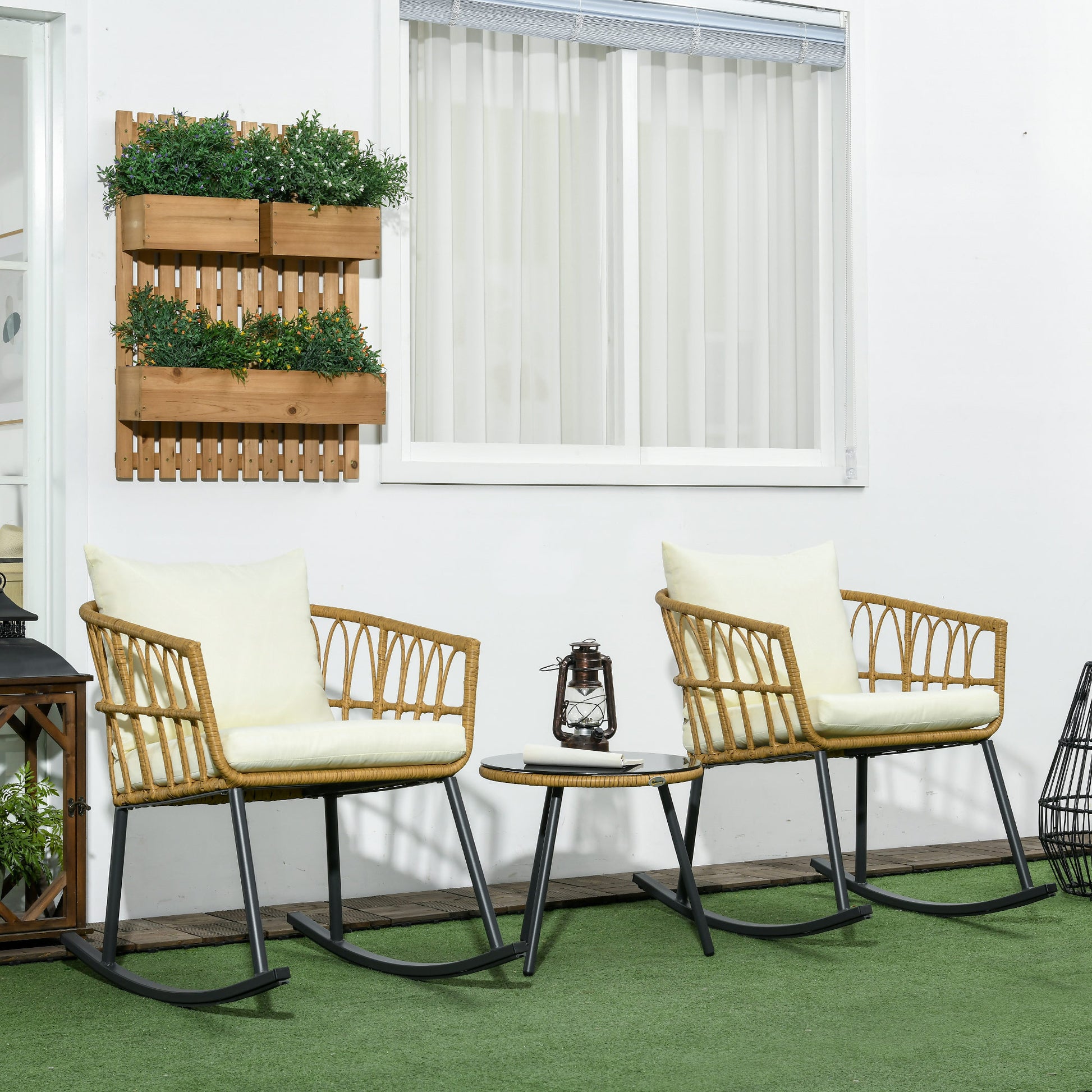 Two natural rattan rocking chairs with cream cushions on green turf