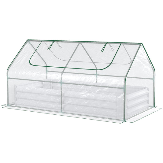 Clear plastic mini greenhouse with a white raised garden bed inside green trim