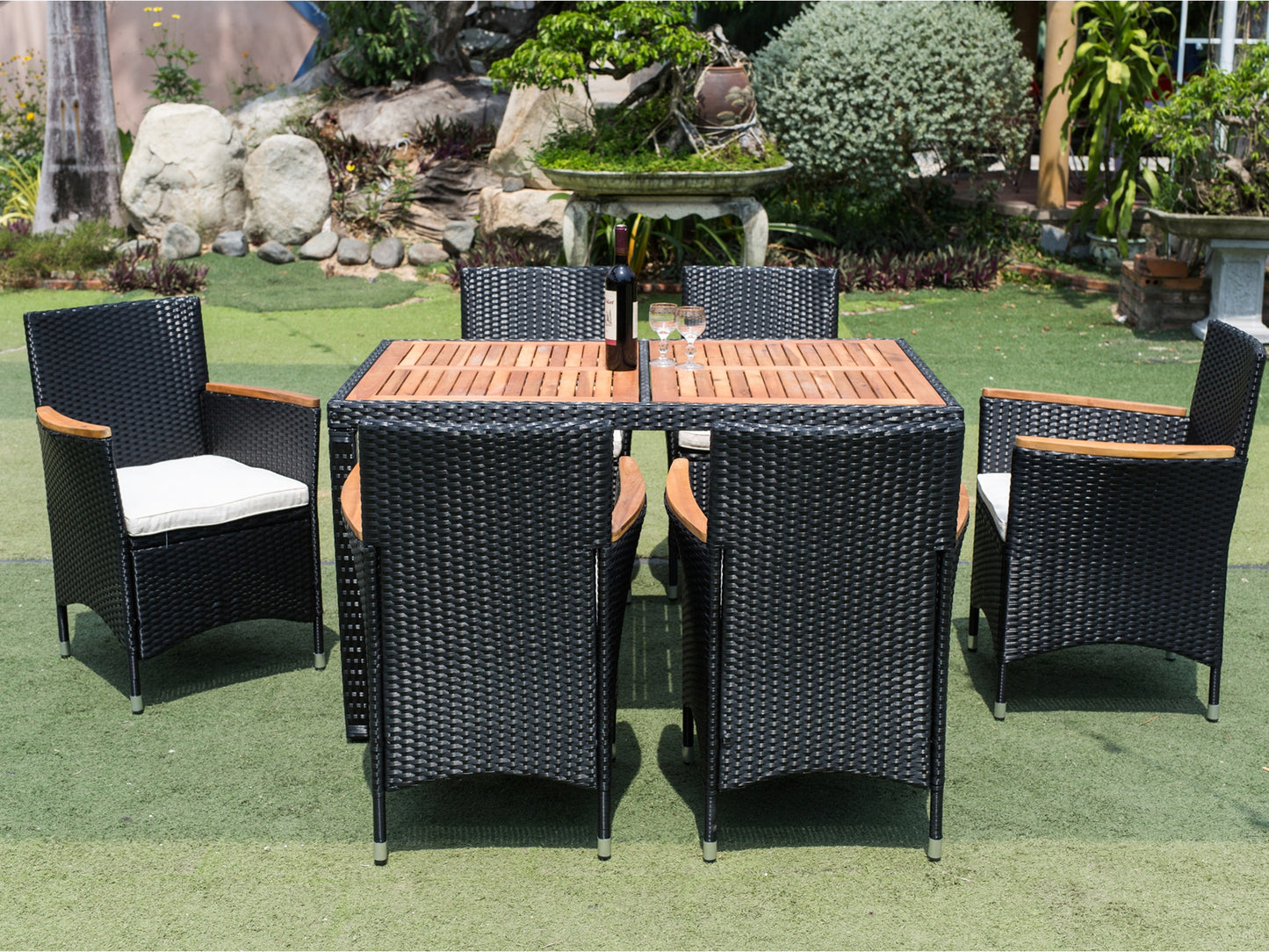 Black wicker dining set with wooden tabletop and white cushions perfect for outdoor entertaining