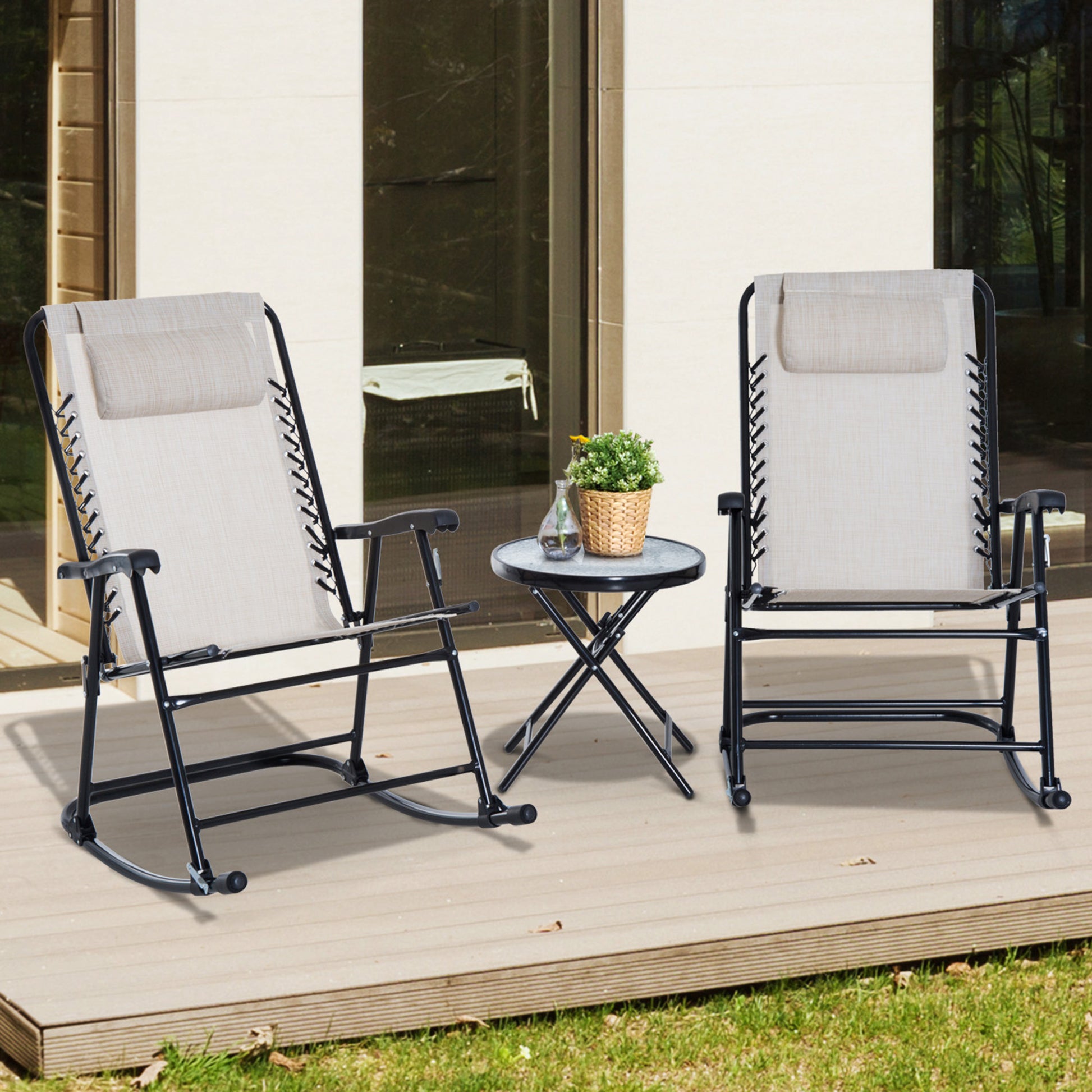 Two beige fabric zero gravity chairs with black metal frames and headrests on a wooden deck