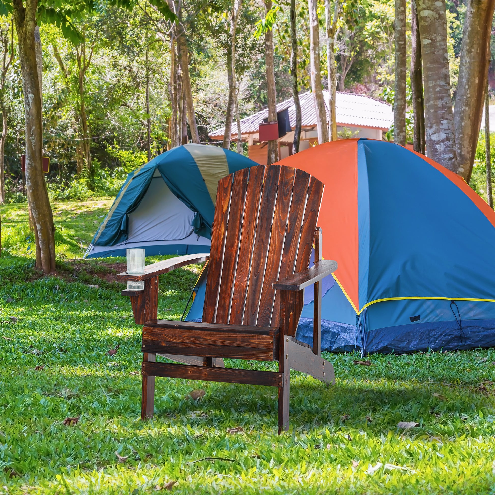 Dark stained wooden Adirondack chair with cupholder at campsite