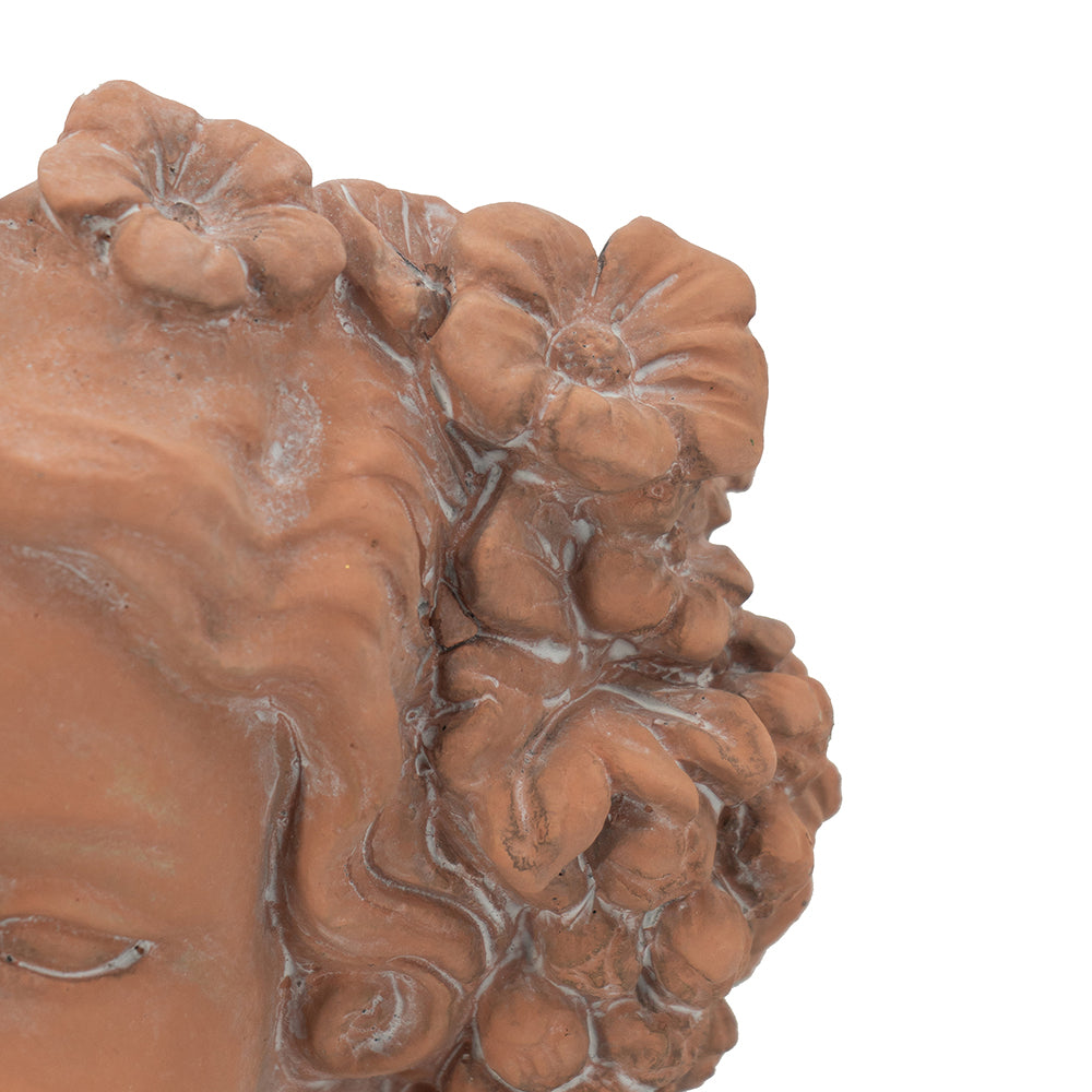 Terracotta garden statue detail of curly hair with floral accents