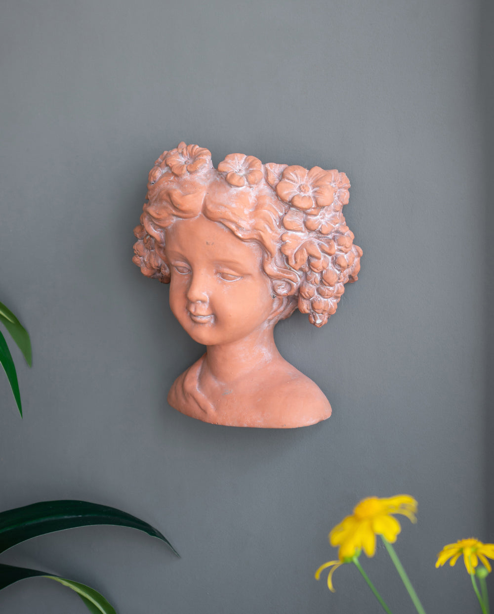 Terracotta girl bust wall planter with flower crown detail for outdoor decor