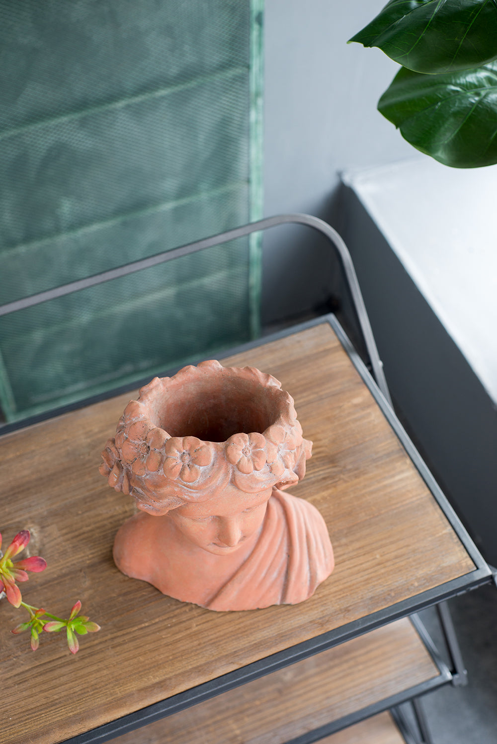 Terracotta bust planter with floral crown detail perfect for small plants