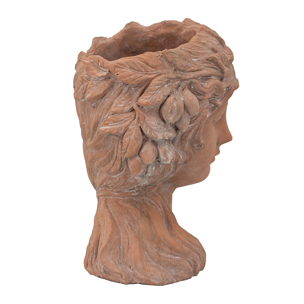 Terracotta bust planter with intricate leaf and fruit detailing on a white background