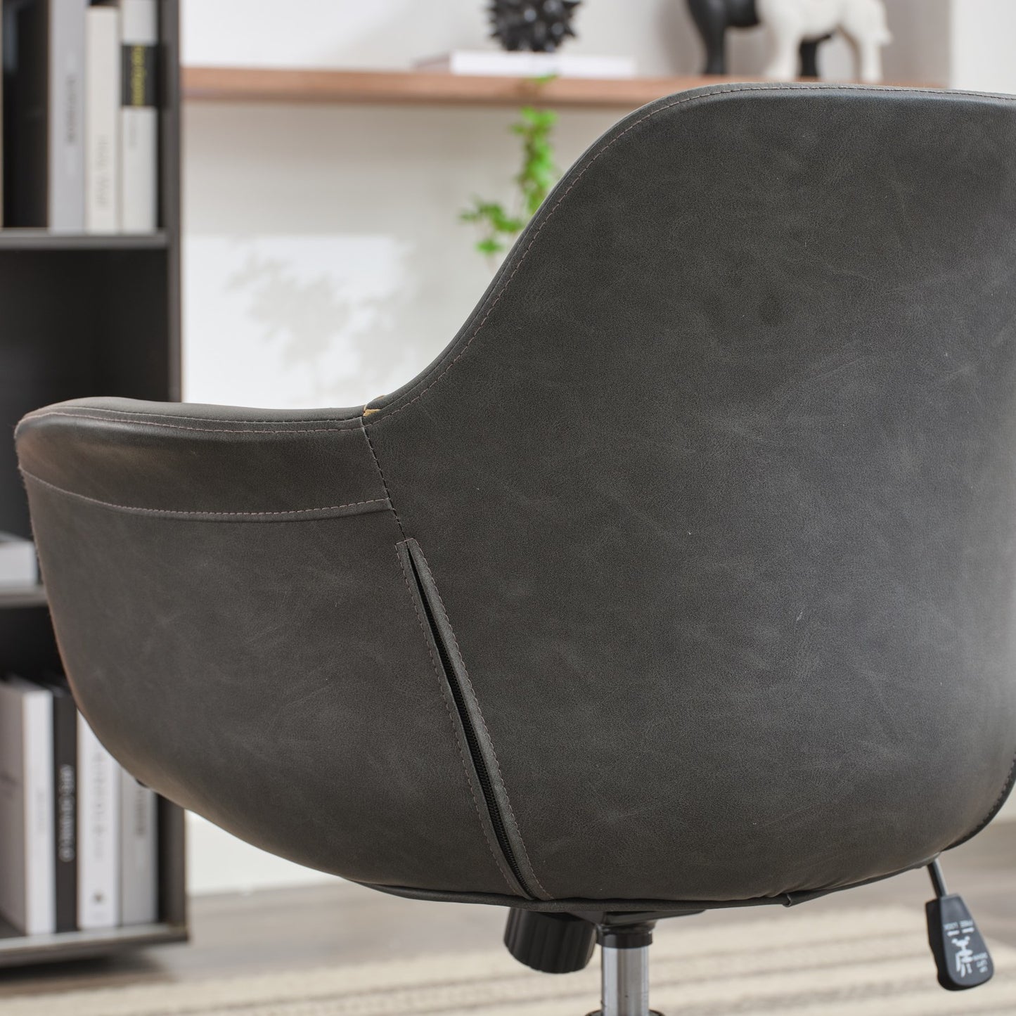 Dark gray faux leather accent chair with stitched detailing for modern home office