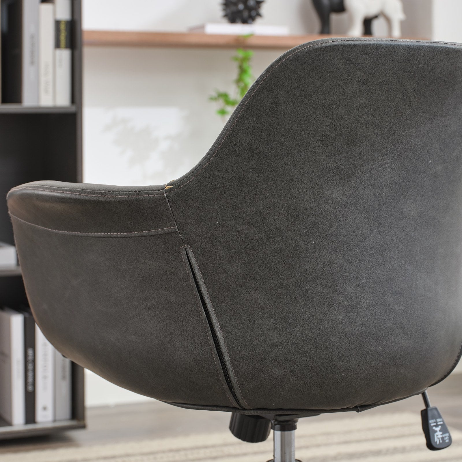 Dark gray faux leather accent chair with stitched detailing for modern home office