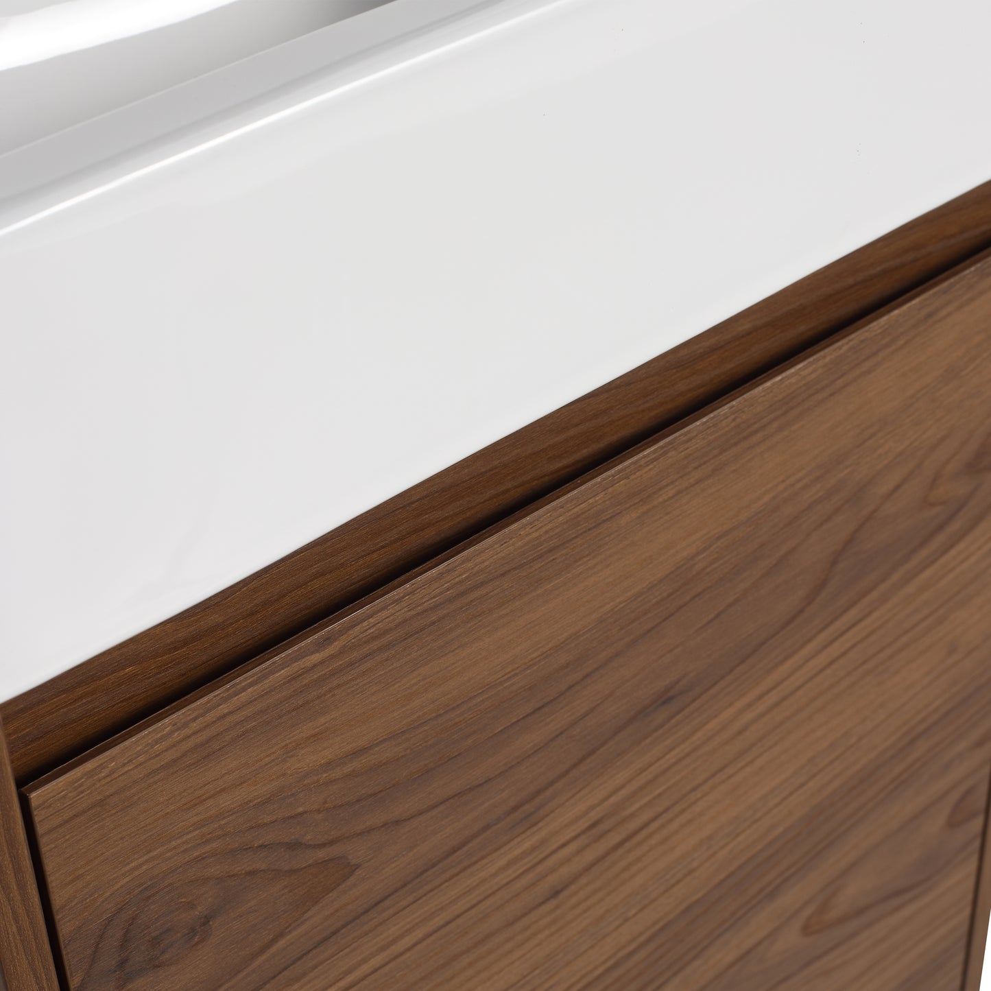 Glossy white vanity top with rich walnut wood cabinet detail