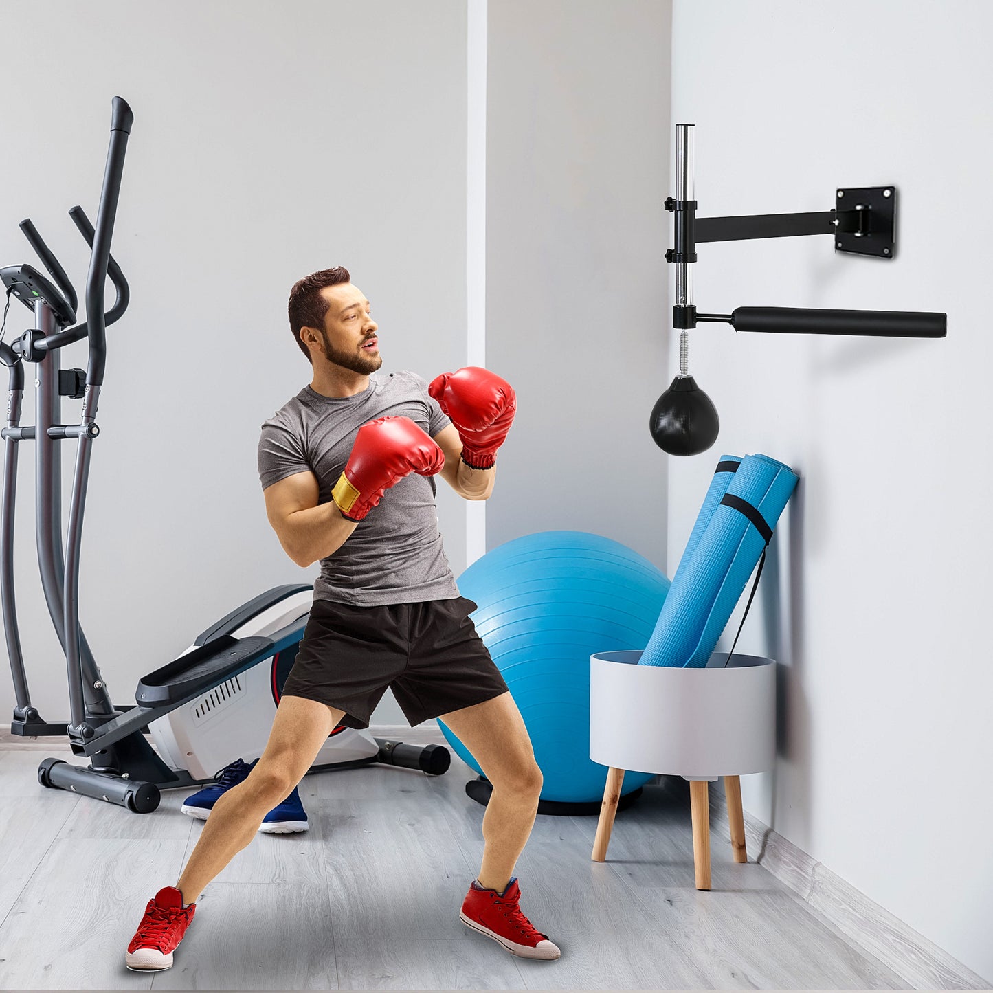 Man in red boxing gloves training on speed bag in home gym