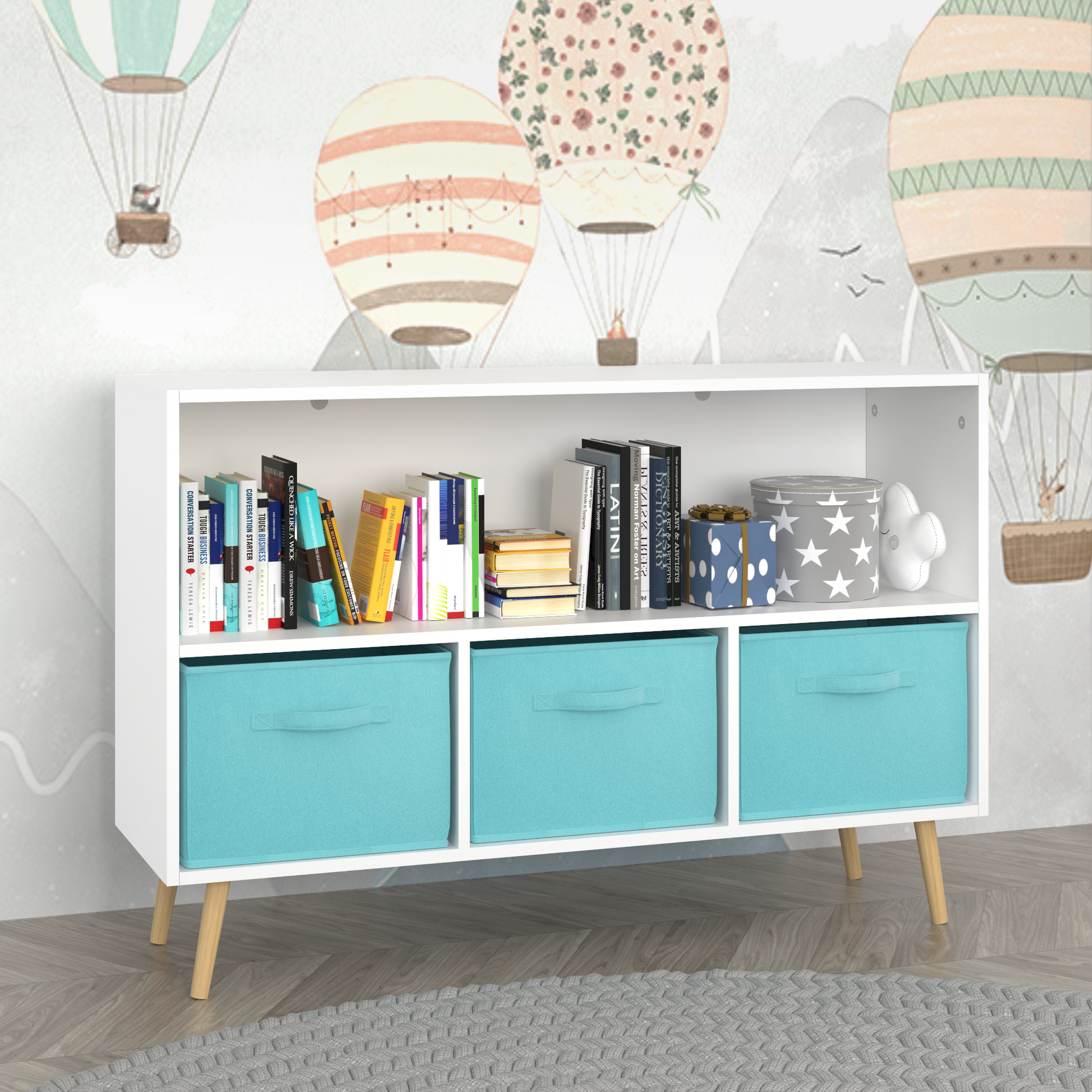 White bookcase with three teal fabric storage cubes and wooden legs displaying books and decor