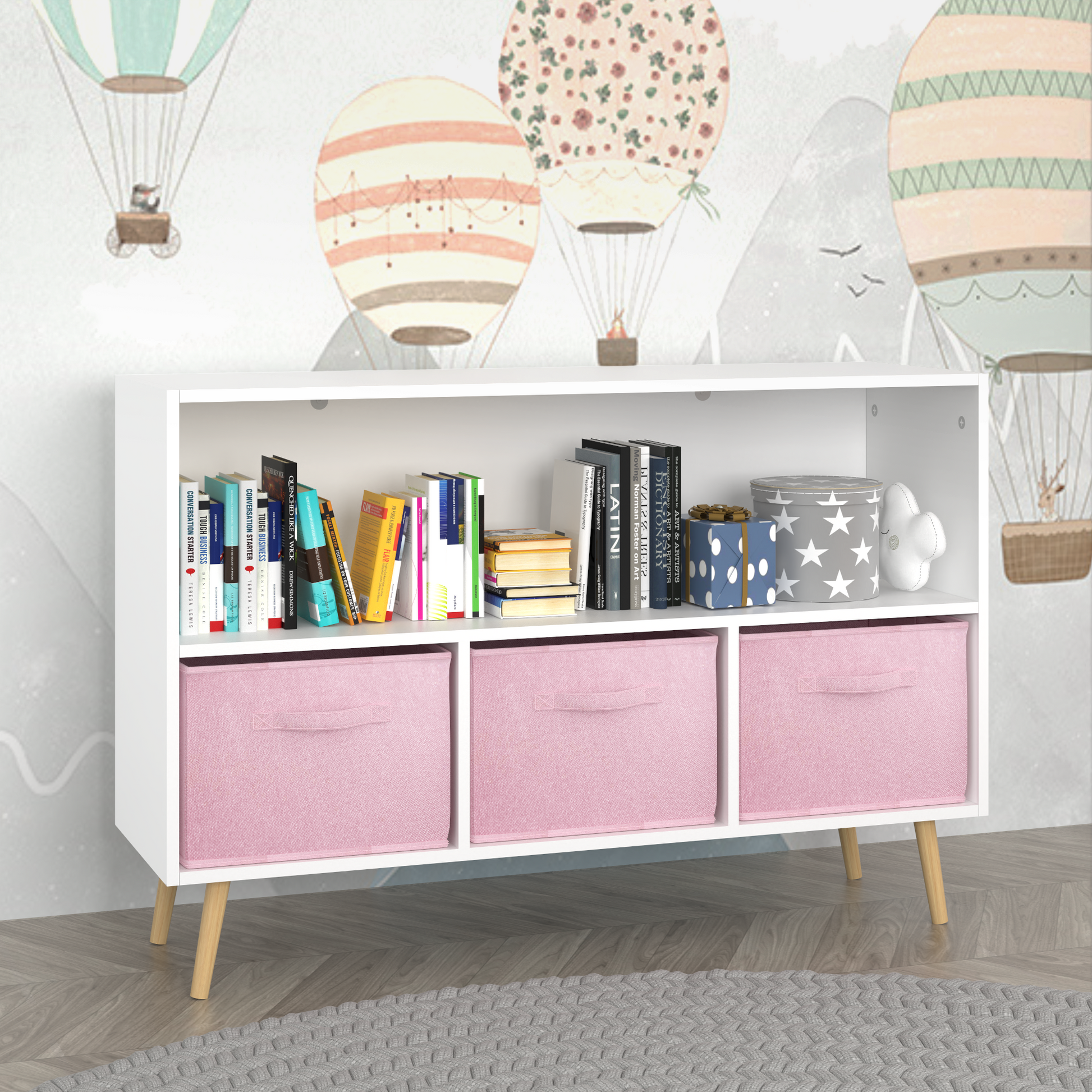 White storage bookcase with three pink fabric bins and wooden legs