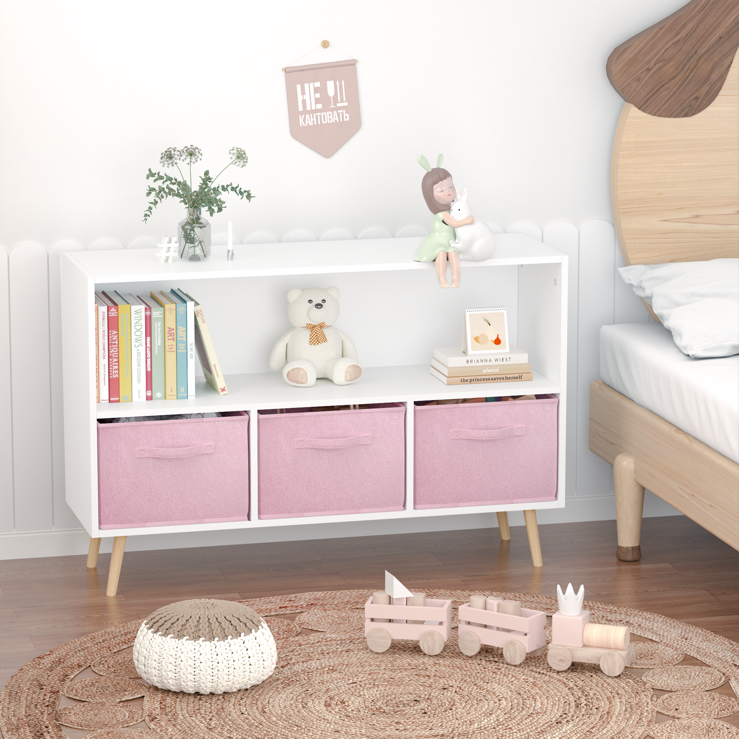 White bookshelf with three pink fabric storage bins and wooden legs