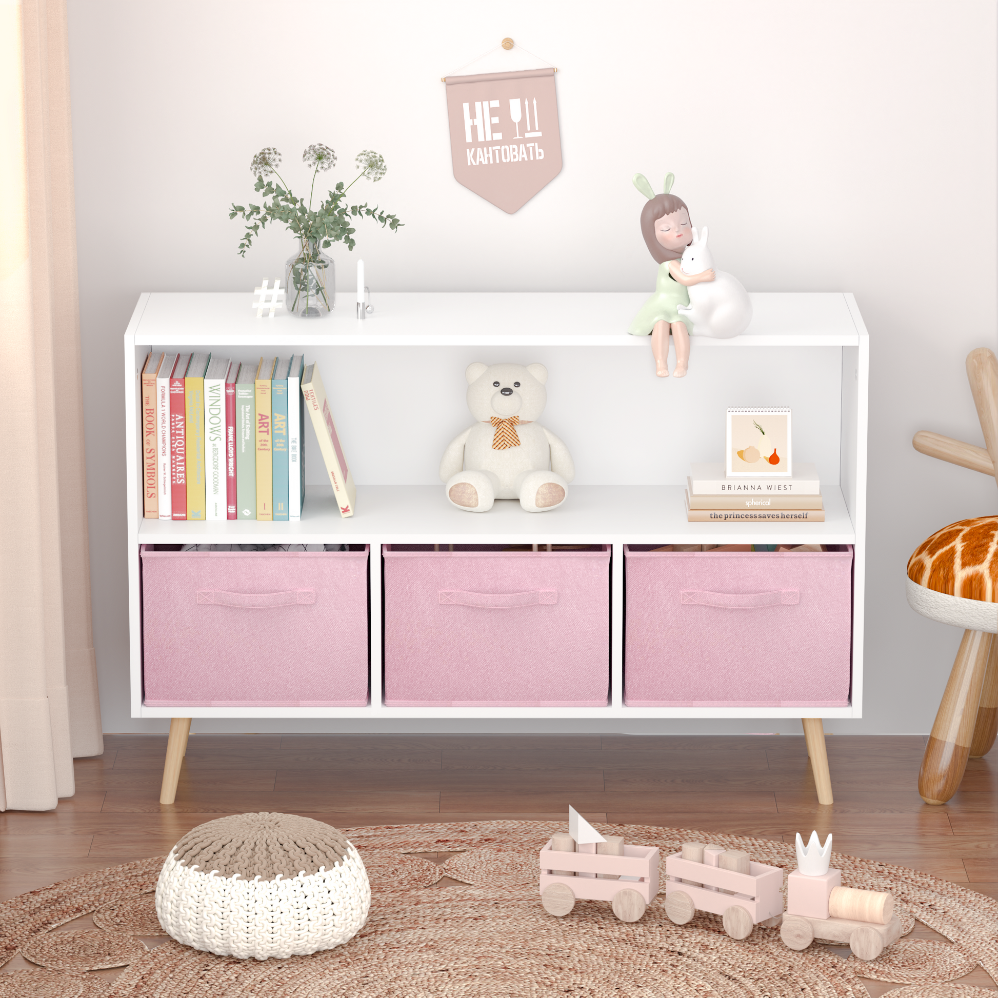 White bookshelf with pink storage cubes and childrens books for nursery organization