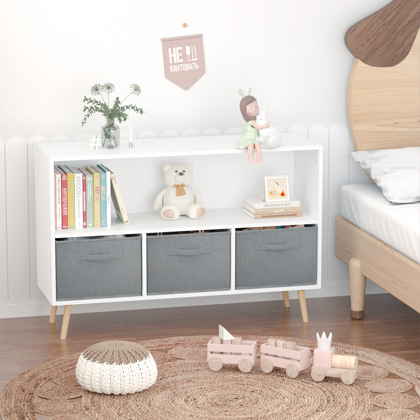 White bookshelf with a teddy bear books and gray storage bins for kids room