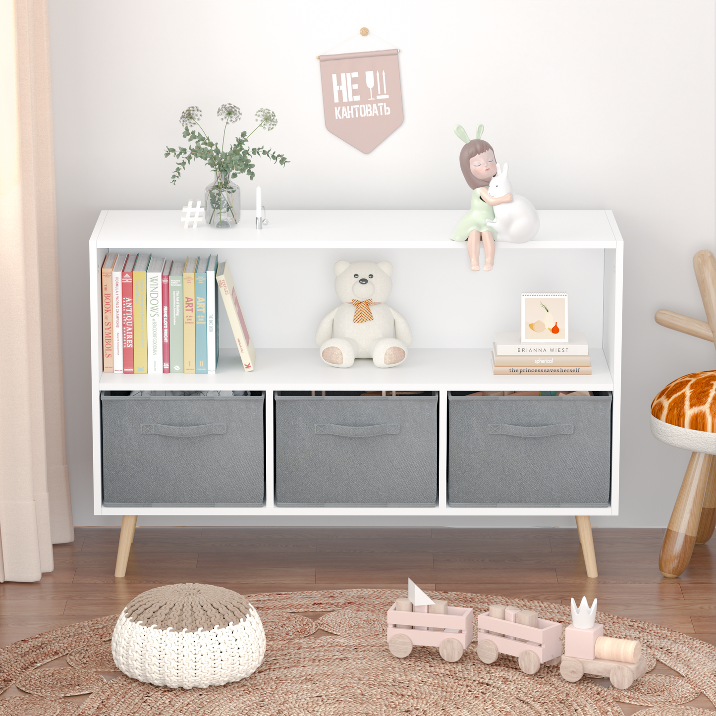White modern bookshelf with three grey fabric storage bins and decorative items