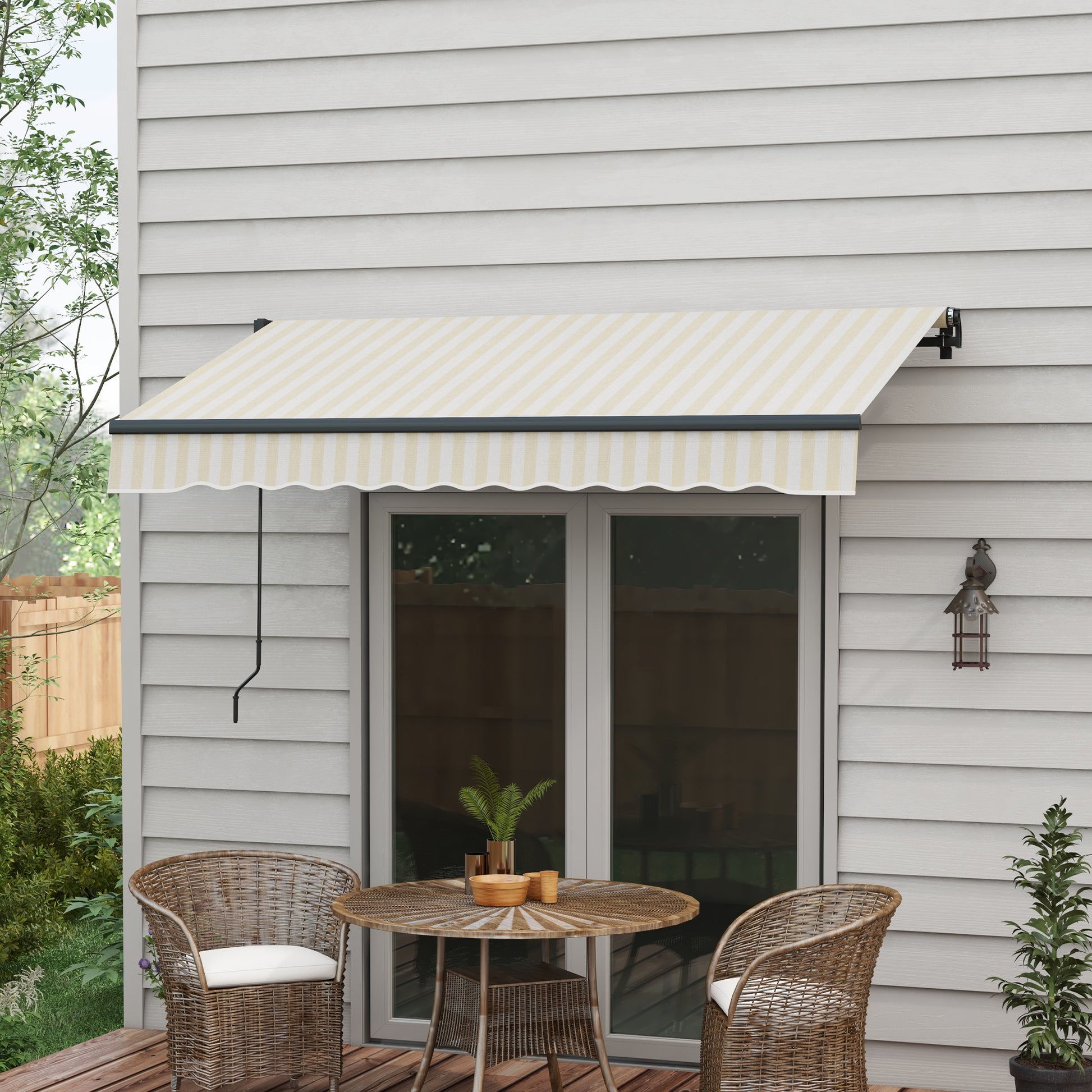Retractable patio awning in cream and yellow stripes extending over a double door