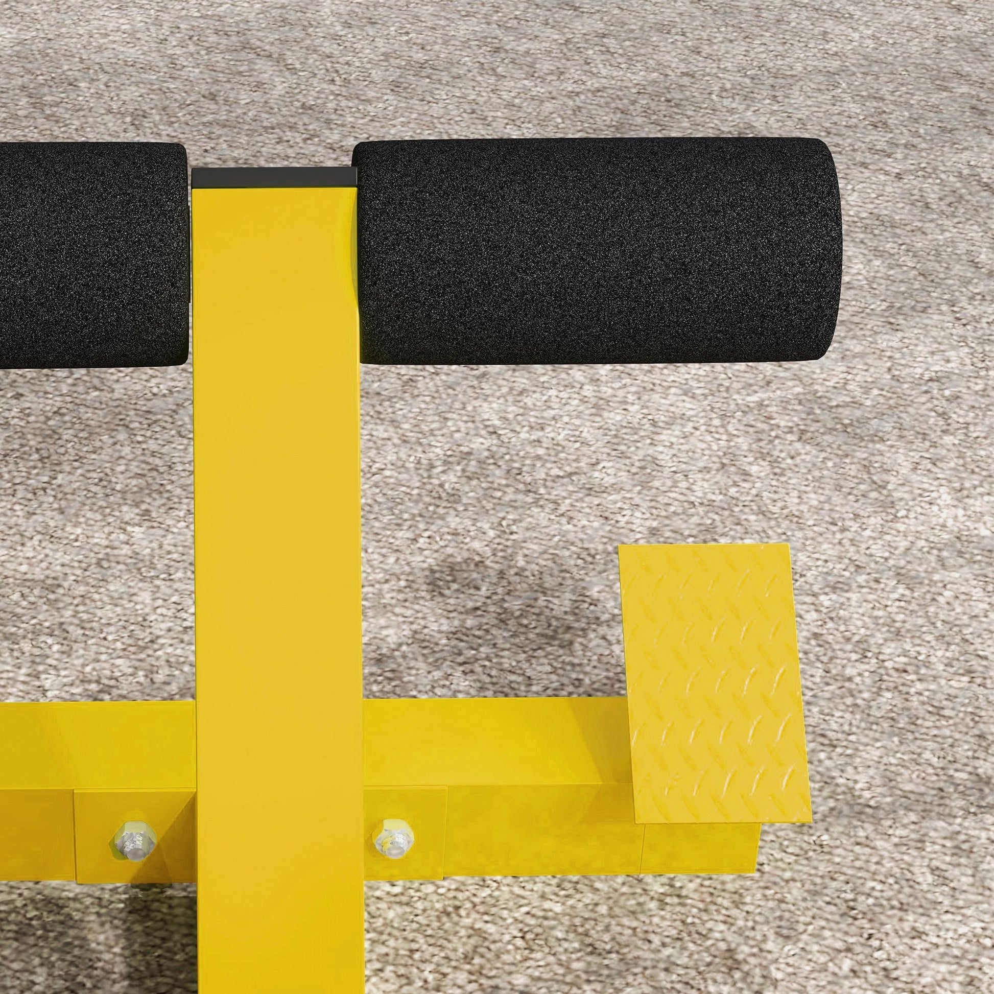 Yellow sit up bench with black foam padding and textured footplate for home gym