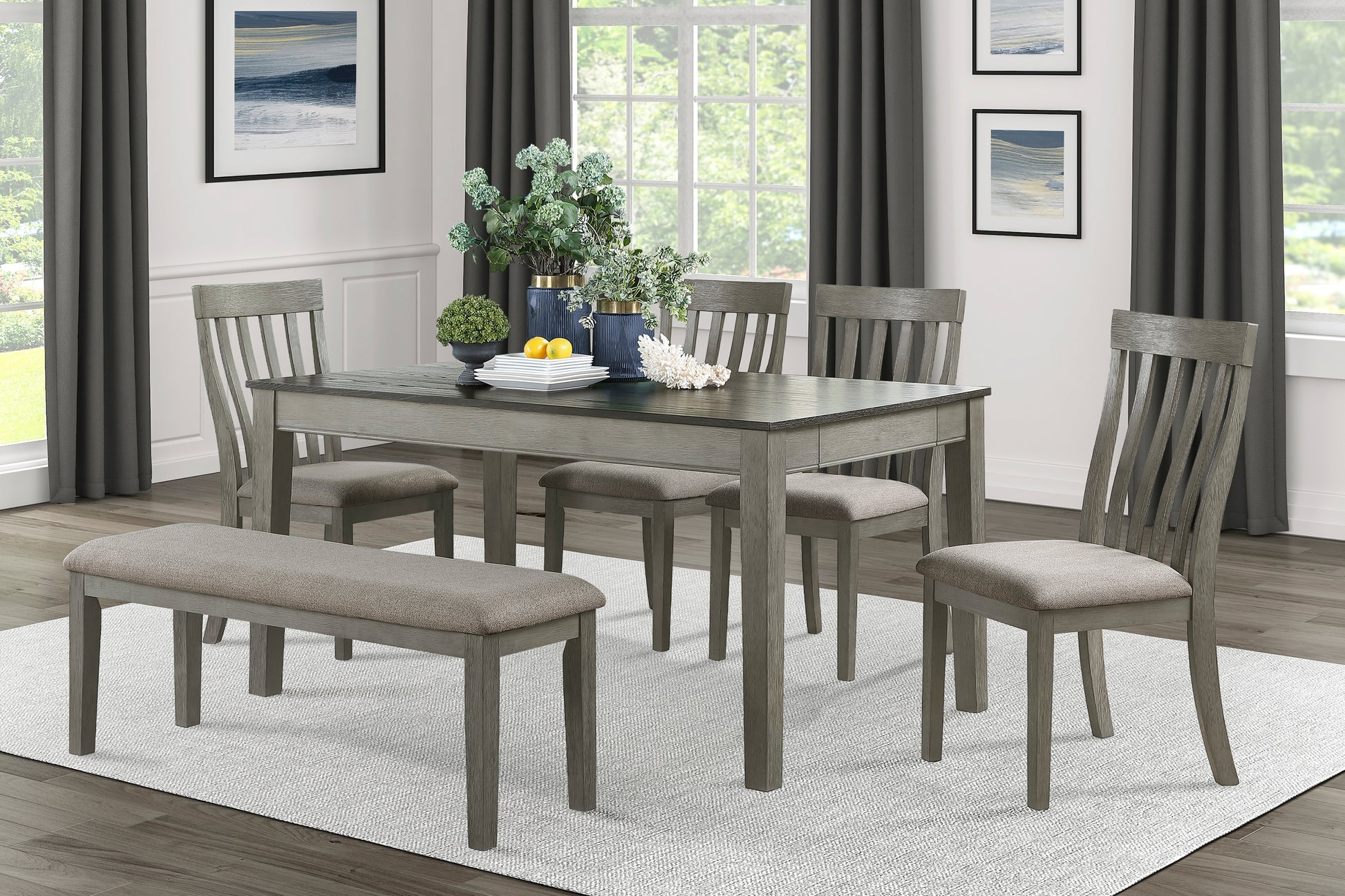 Gray wash dining table with slatted chairs and upholstered bench