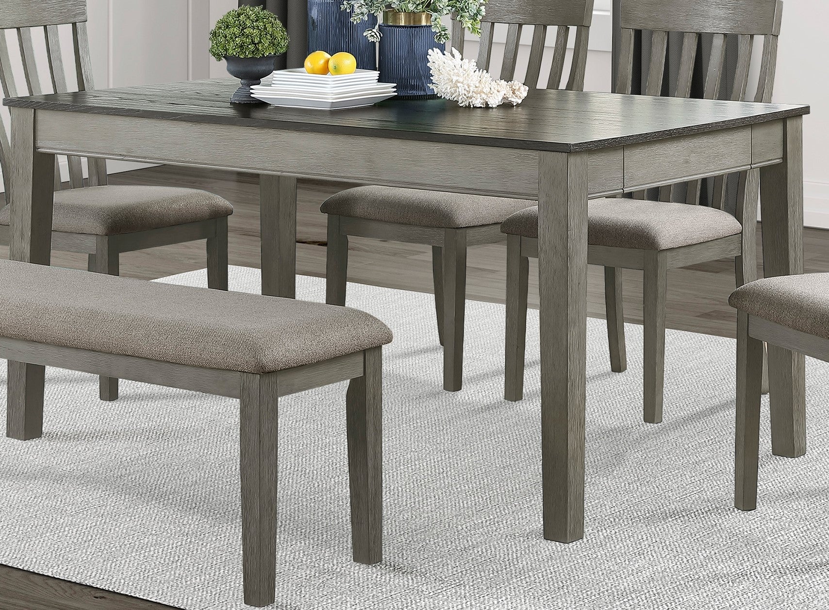 Gray wood dining table with bench and upholstered chairs