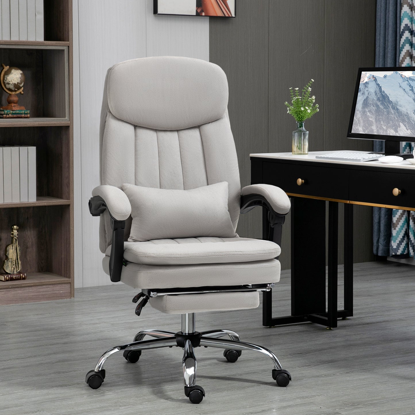 Comfortable gray ergonomic office chair with lumbar pillow and footrest
