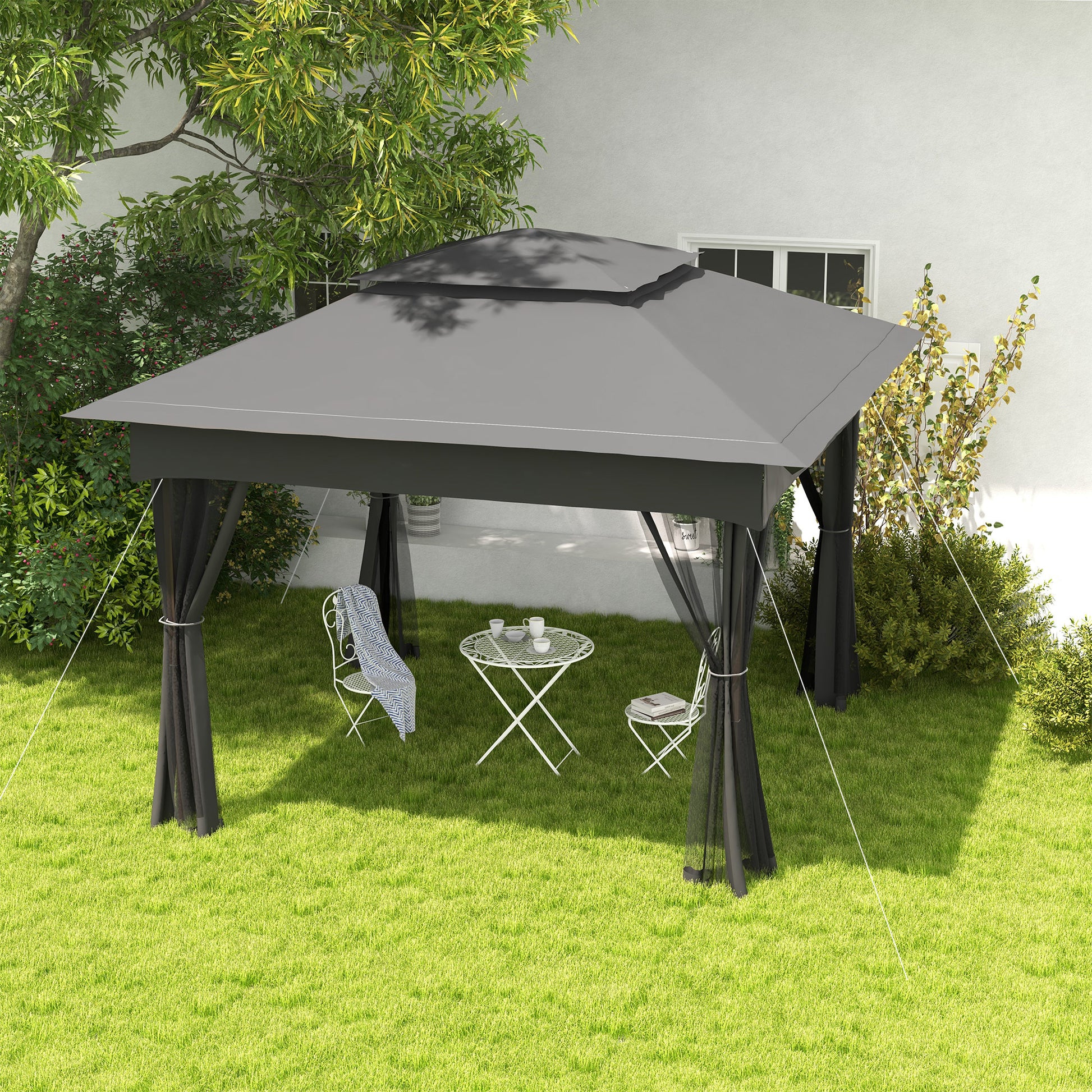 Dark grey outdoor gazebo with sheer black curtains and metal patio furniture
