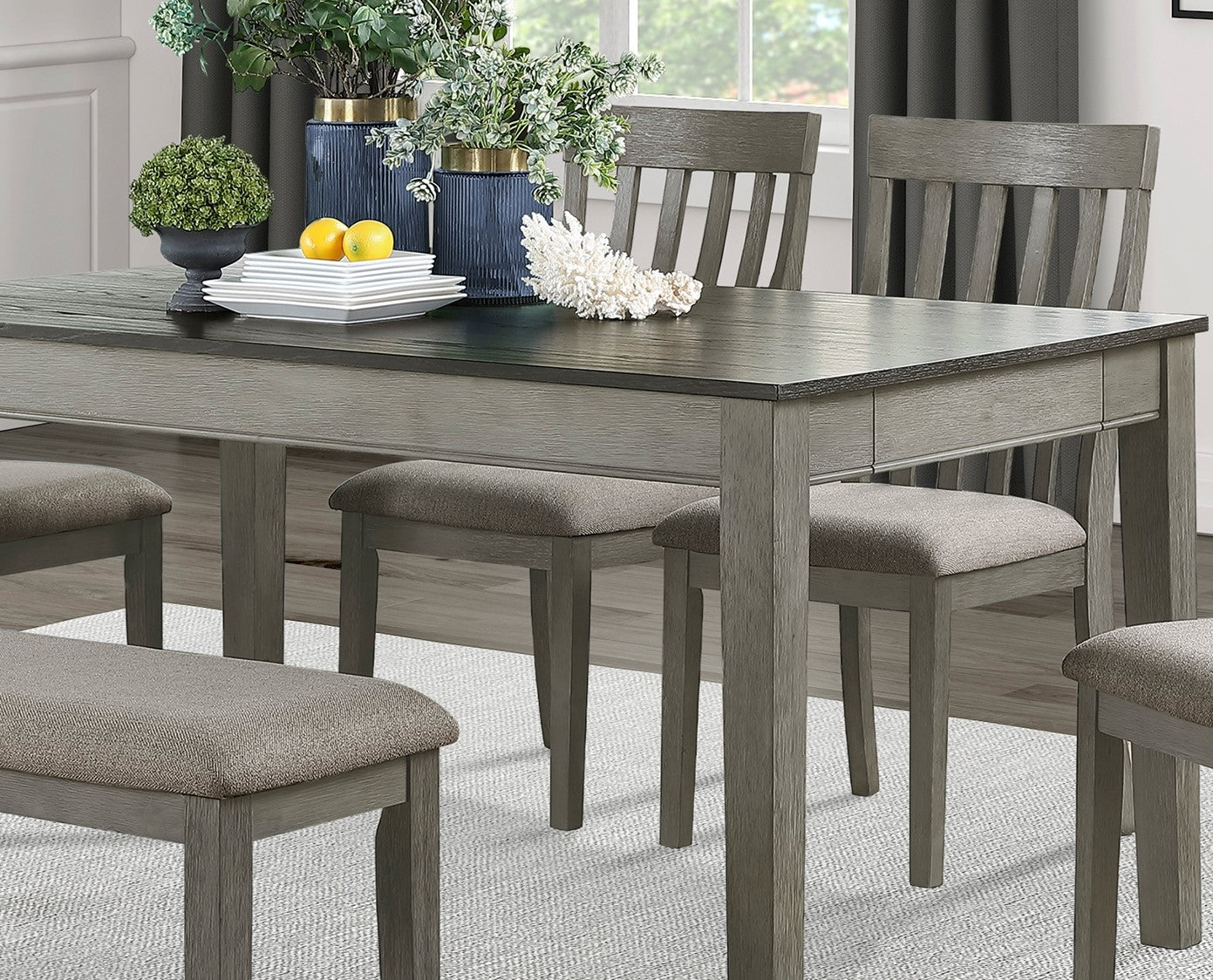 Gray rustic dining table with upholstered bench seating