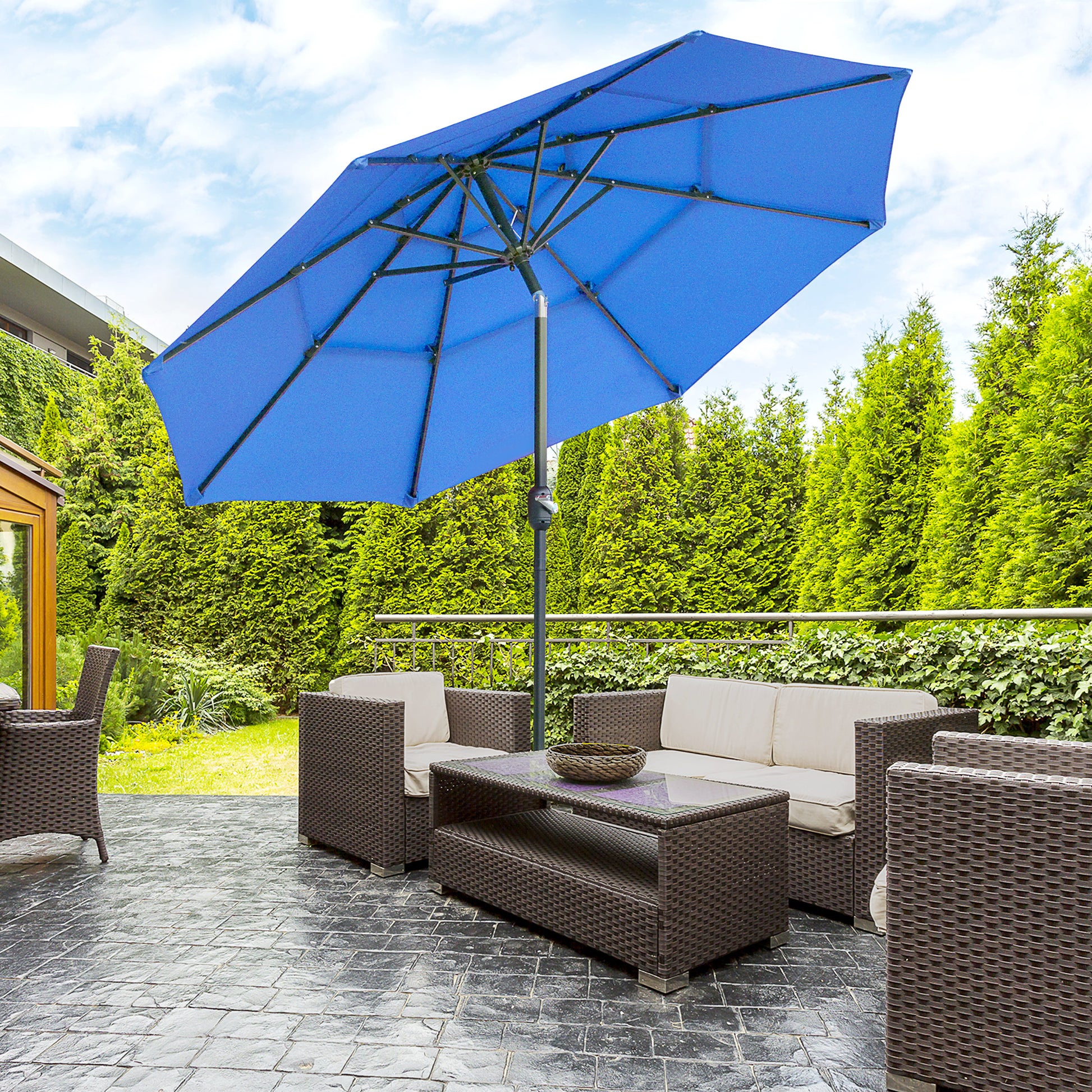 Large blue cantilever patio umbrella providing shade over rattan furniture set outdoors