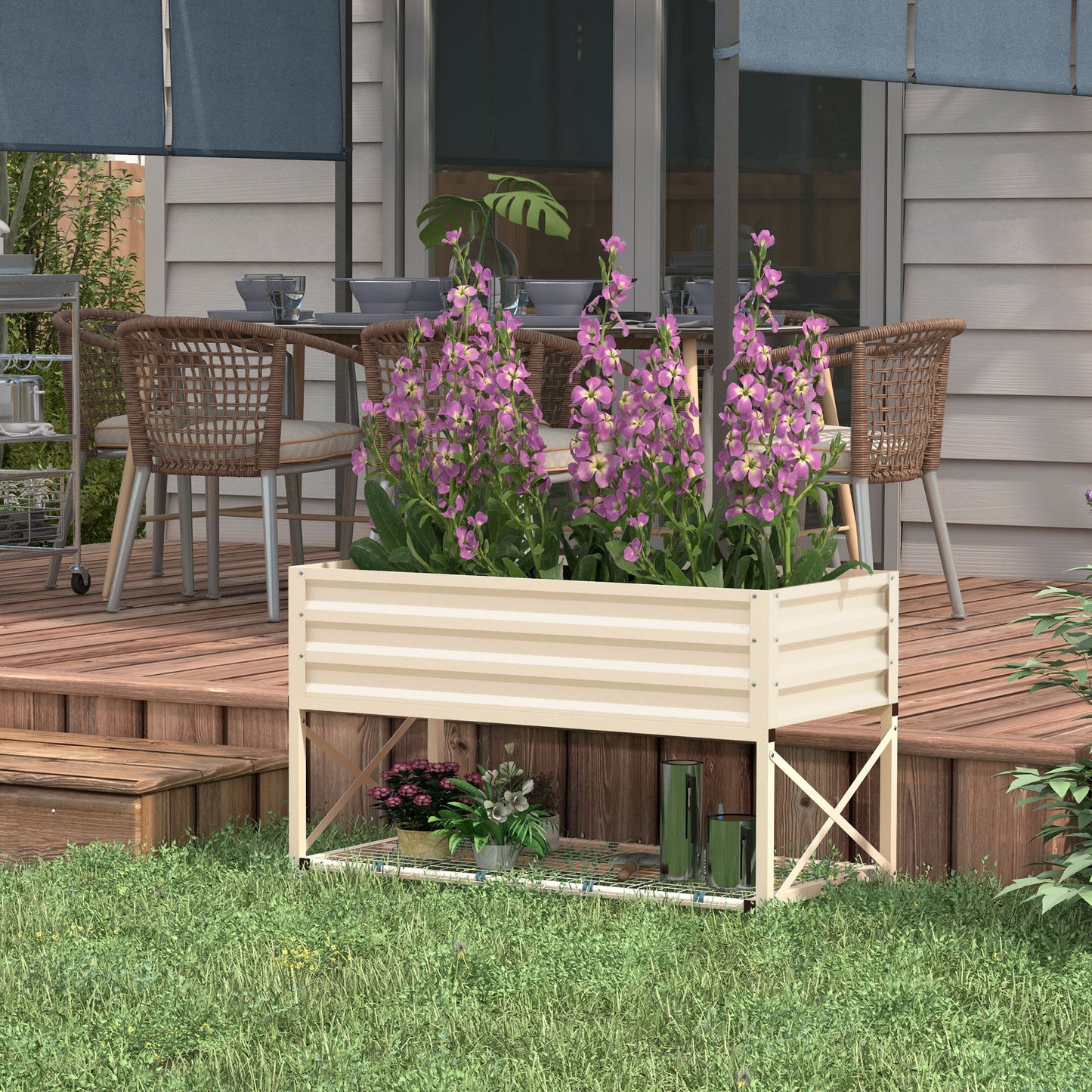 Elevated cream planter with striped design holding purple flowers on a wooden deck