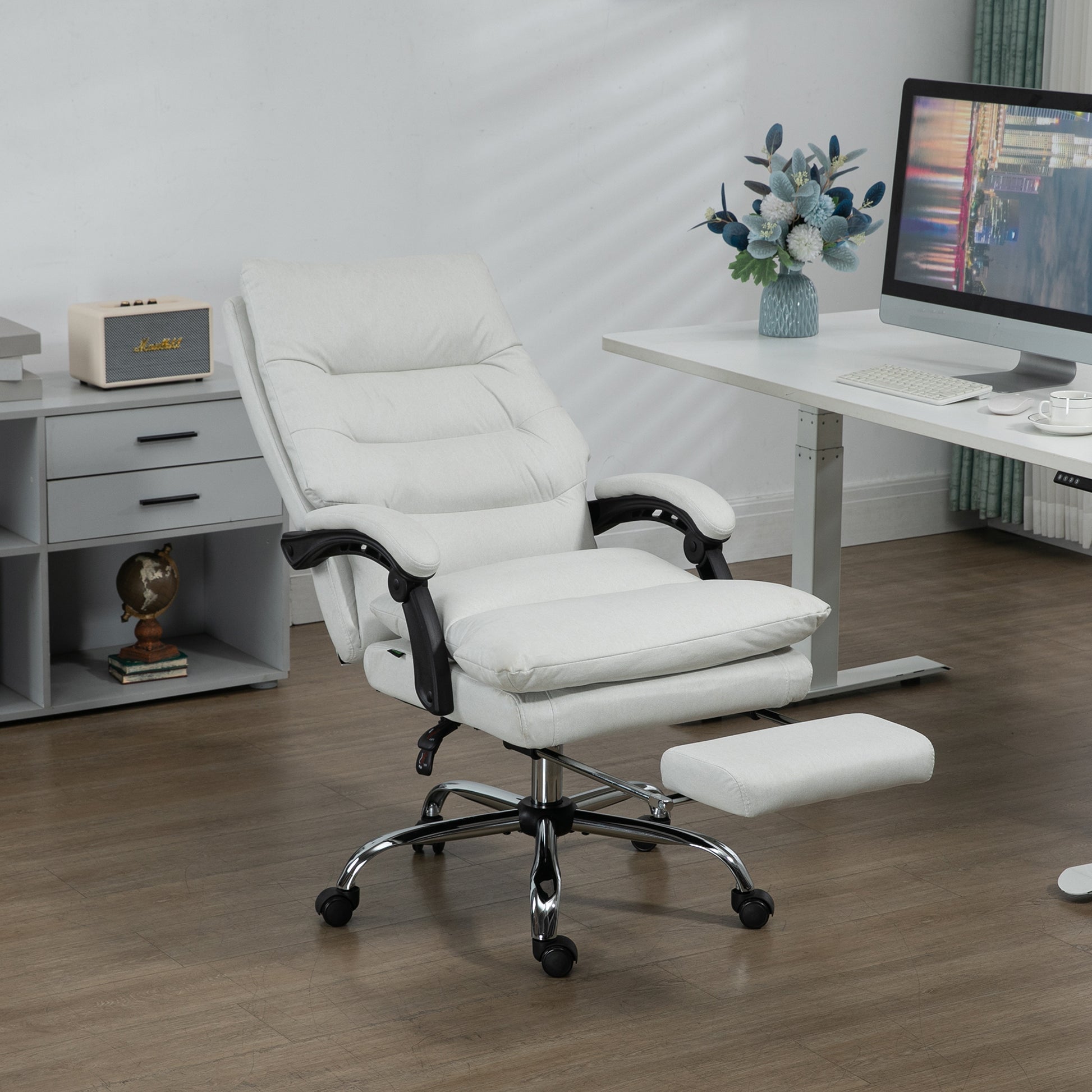 White executive office chair with adjustable footrest and chrome base