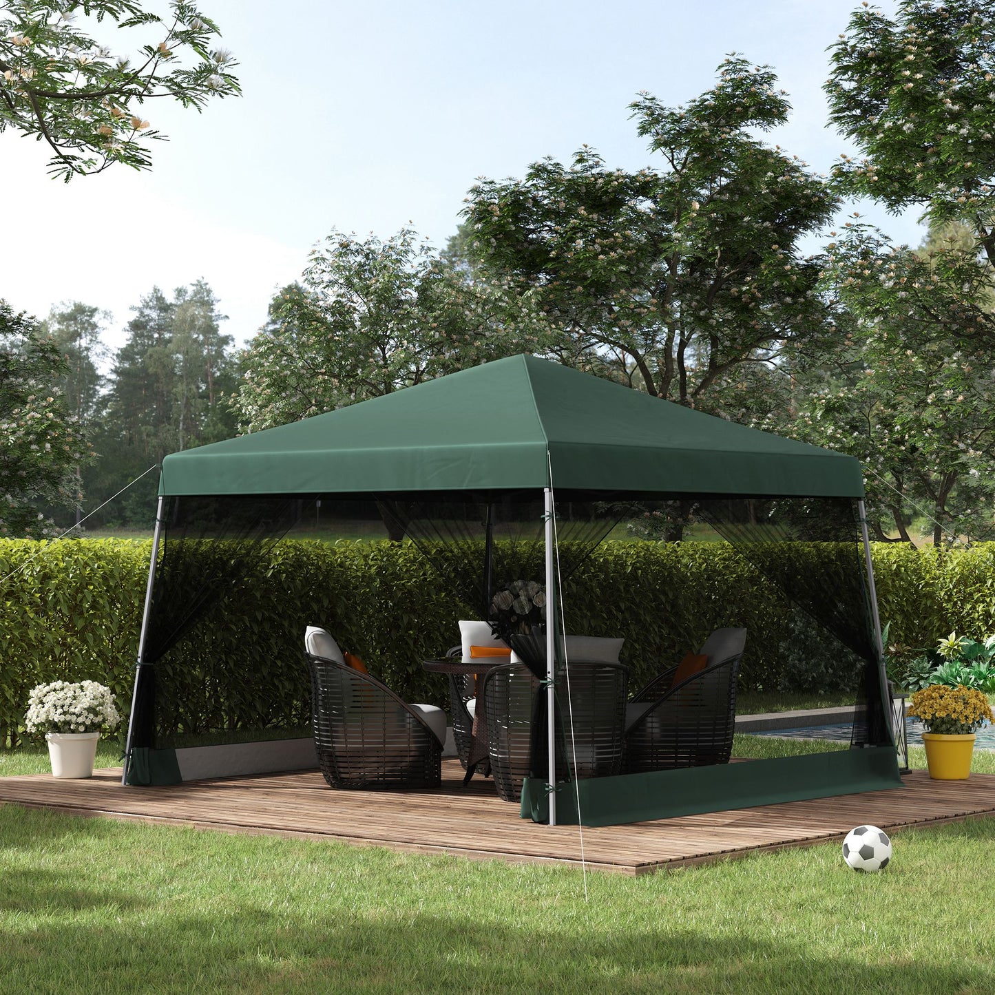 Green patio canopy tent with mesh sides and outdoor furniture for backyard relaxation