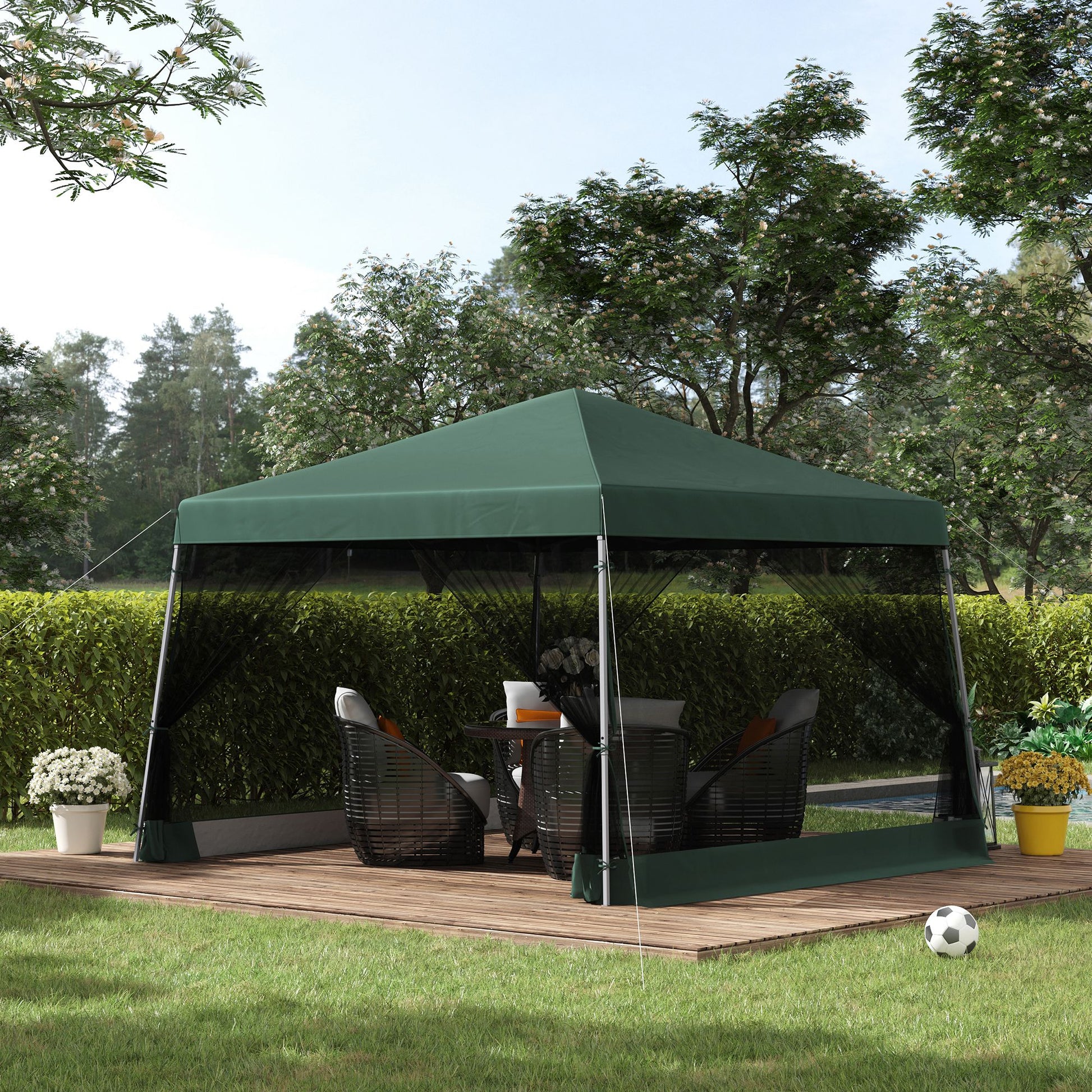 Green patio canopy tent with mesh sides and outdoor furniture for backyard relaxation
