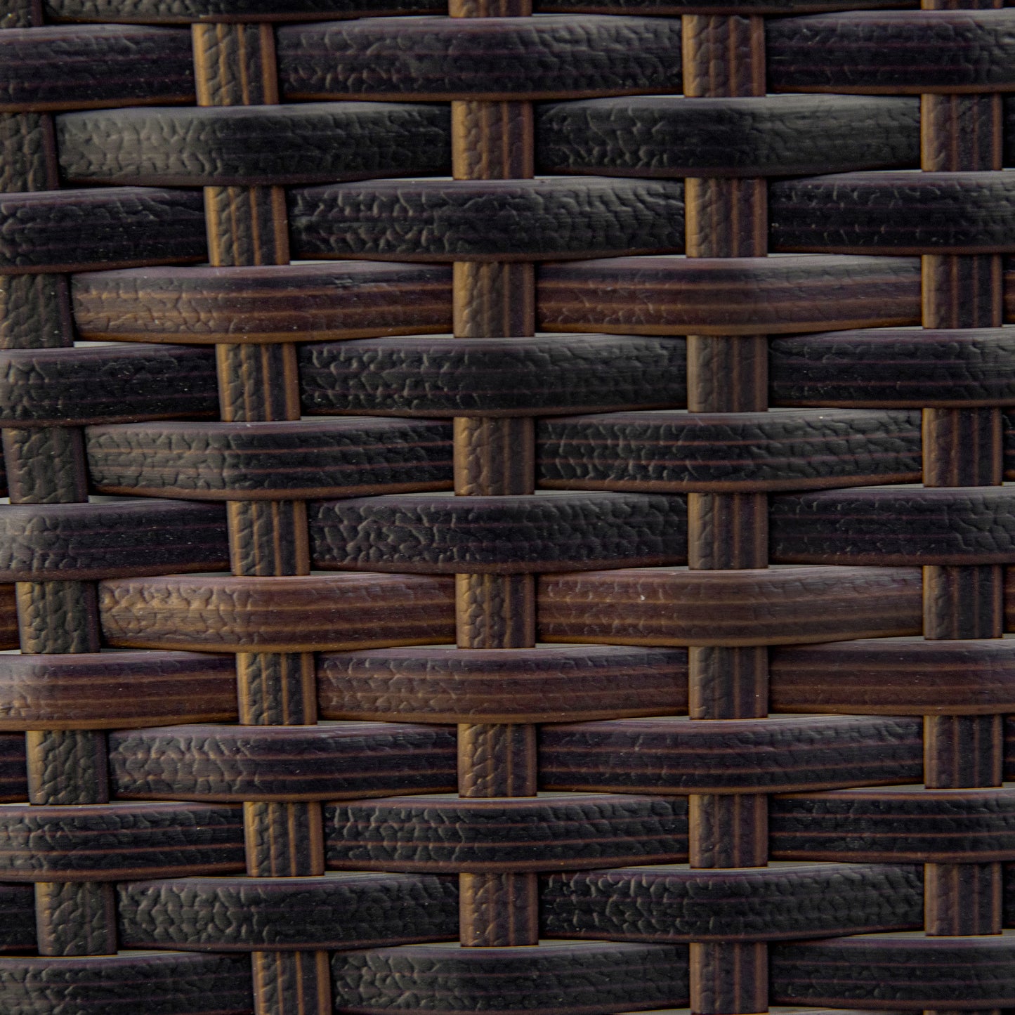 Closeup of dark brown wicker weave texture on outdoor furniture