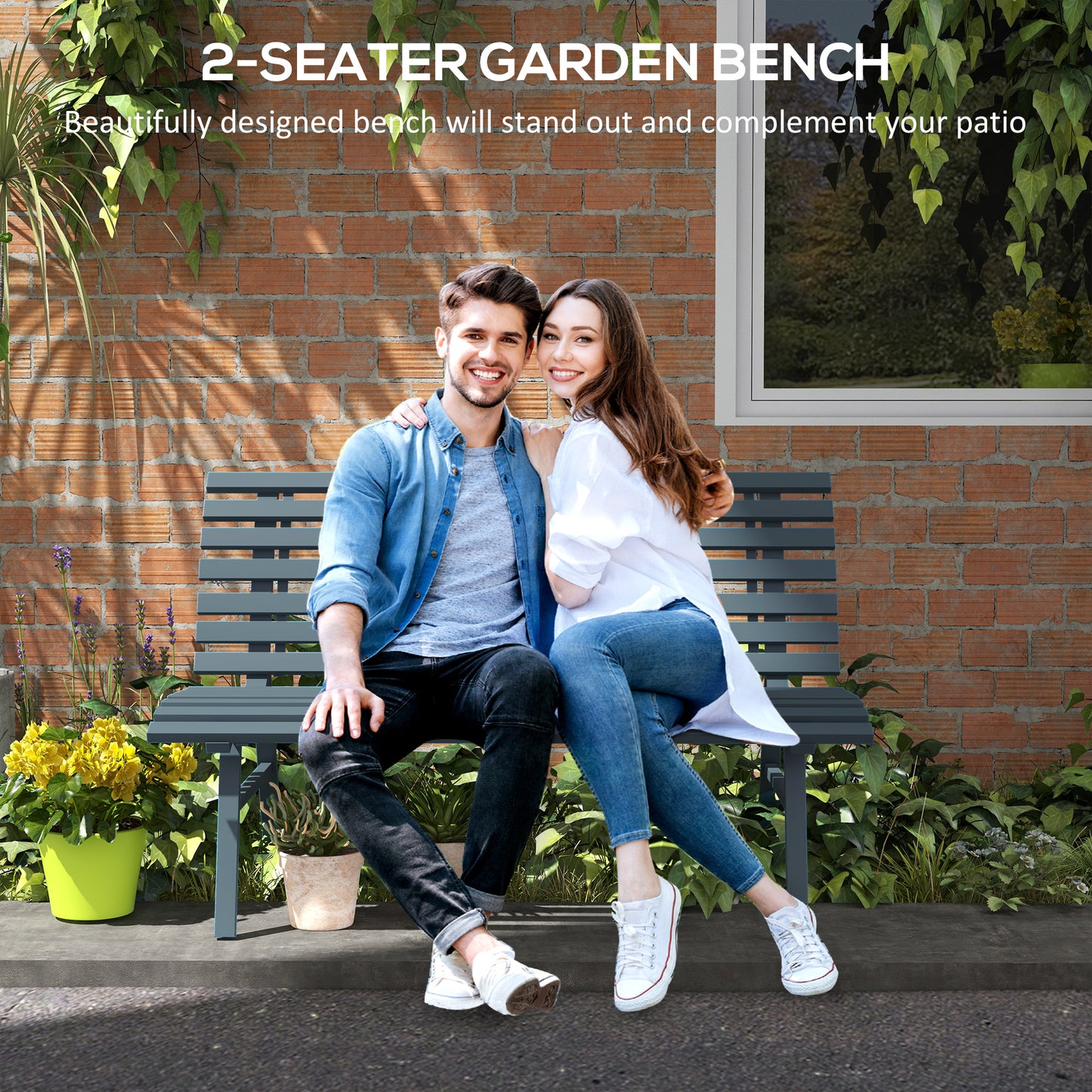 Dark grey metal seater garden bench with slatted seat and back shown outdoors