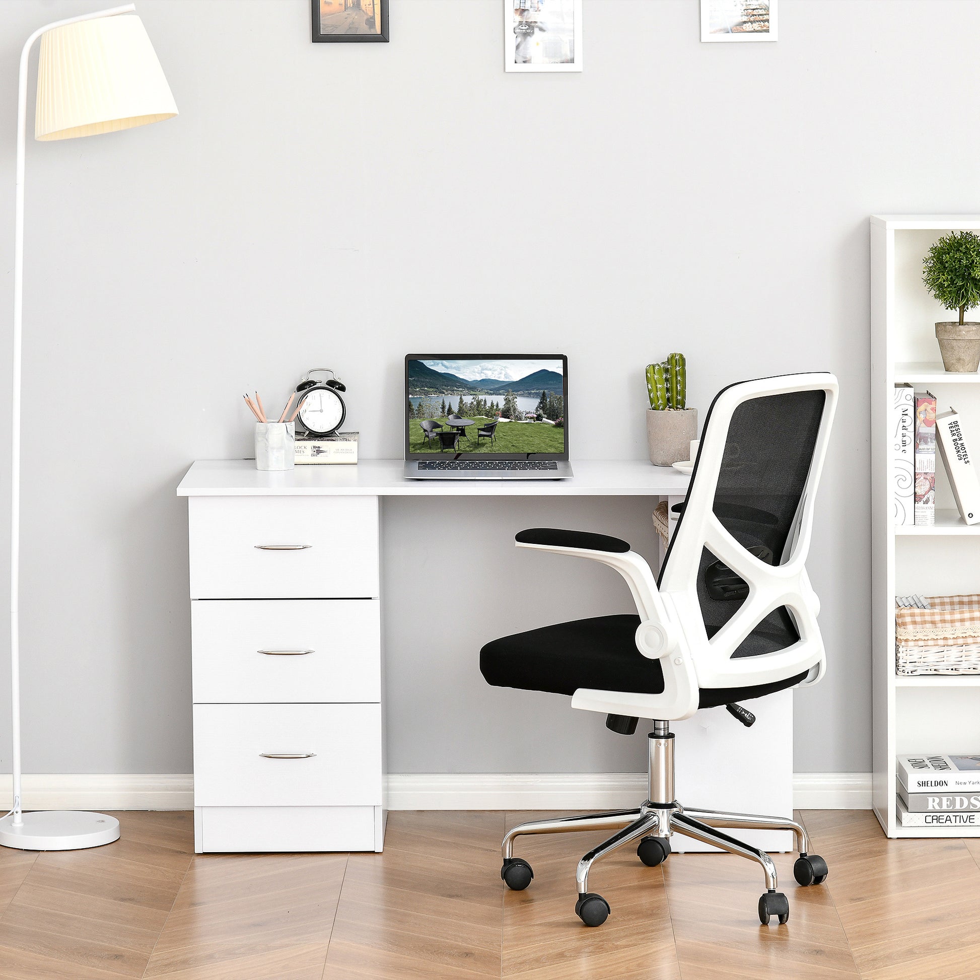 White minimalist desk with three drawers and a laptop for modern home office setup