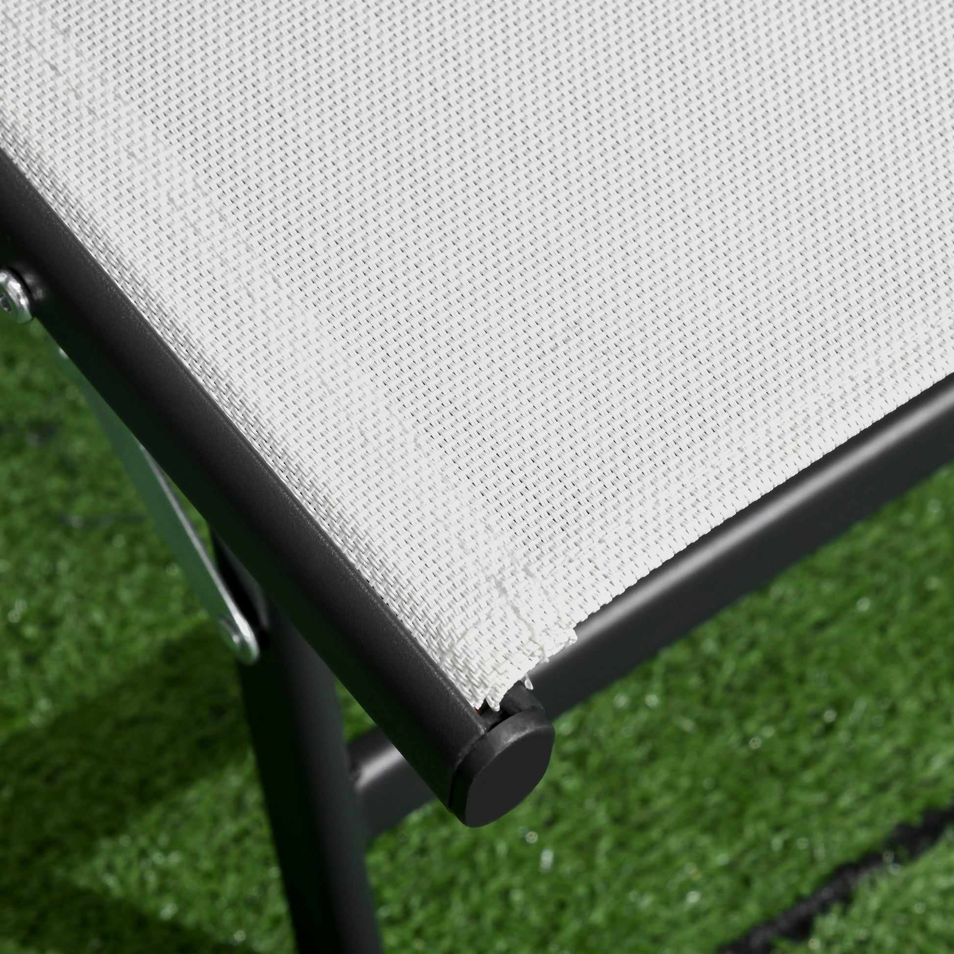 Close up of a white mesh fabric patio chair with black frame