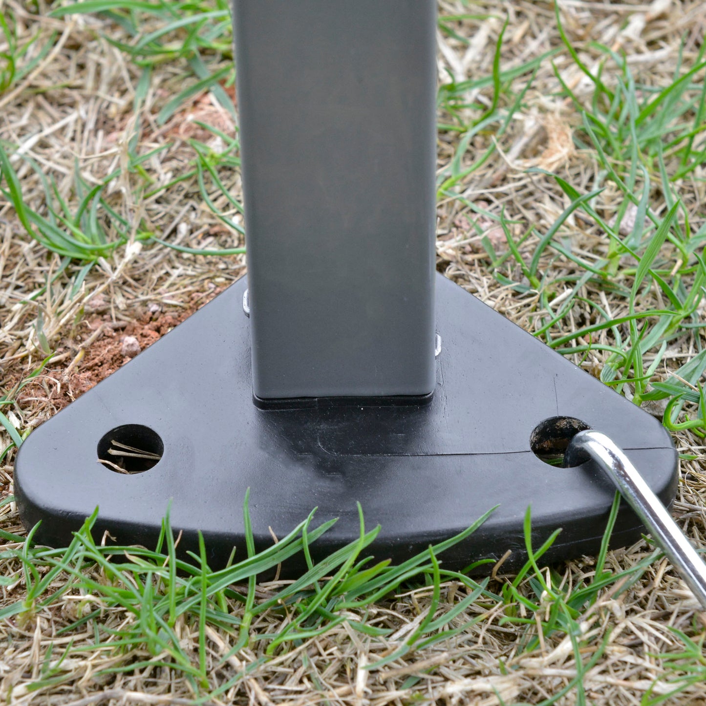 Black plastic tent stake base with ground peg for outdoor use