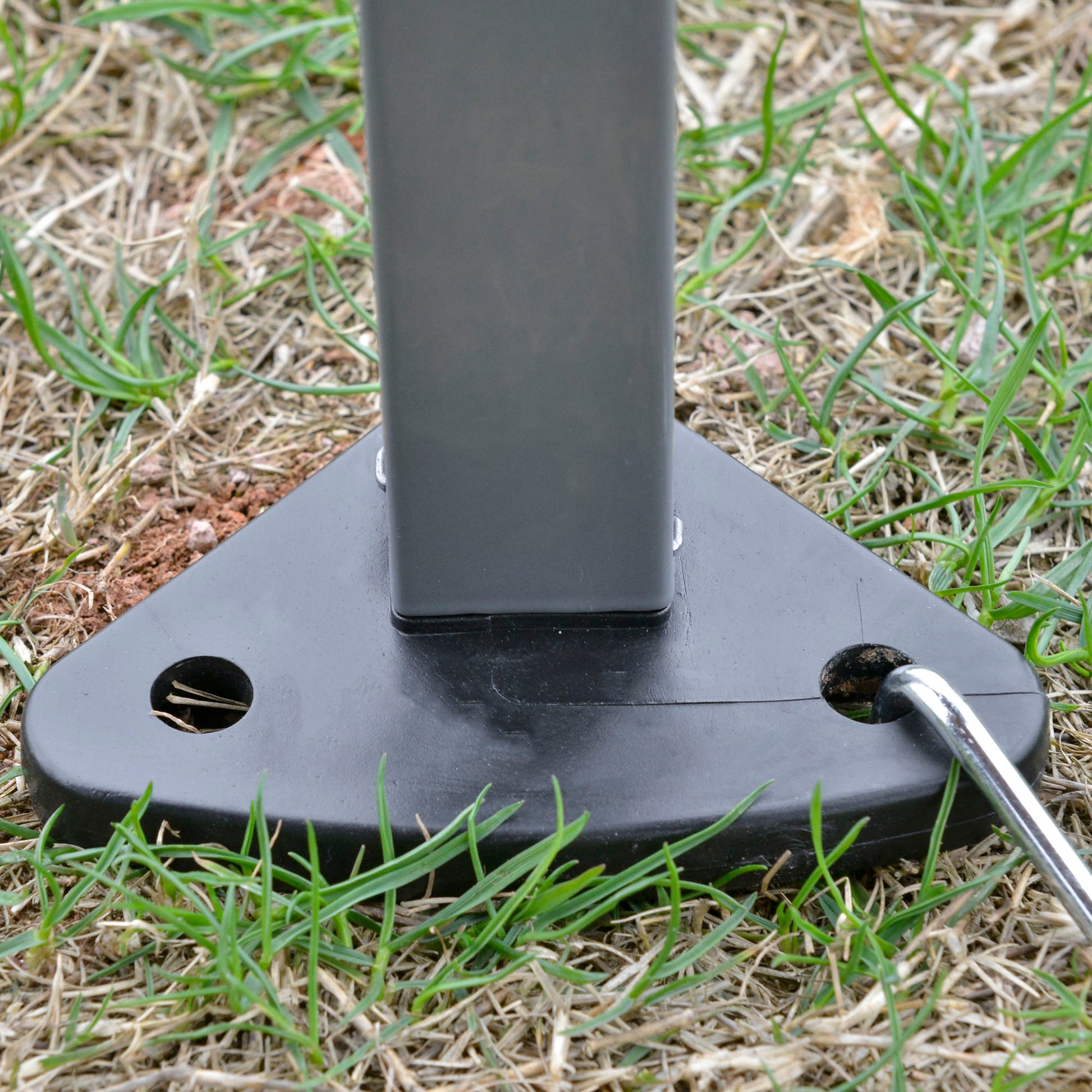 Black plastic tent stake base with ground peg for outdoor use