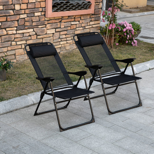 Two black mesh zero gravity chairs with padded headrests on a stone patio