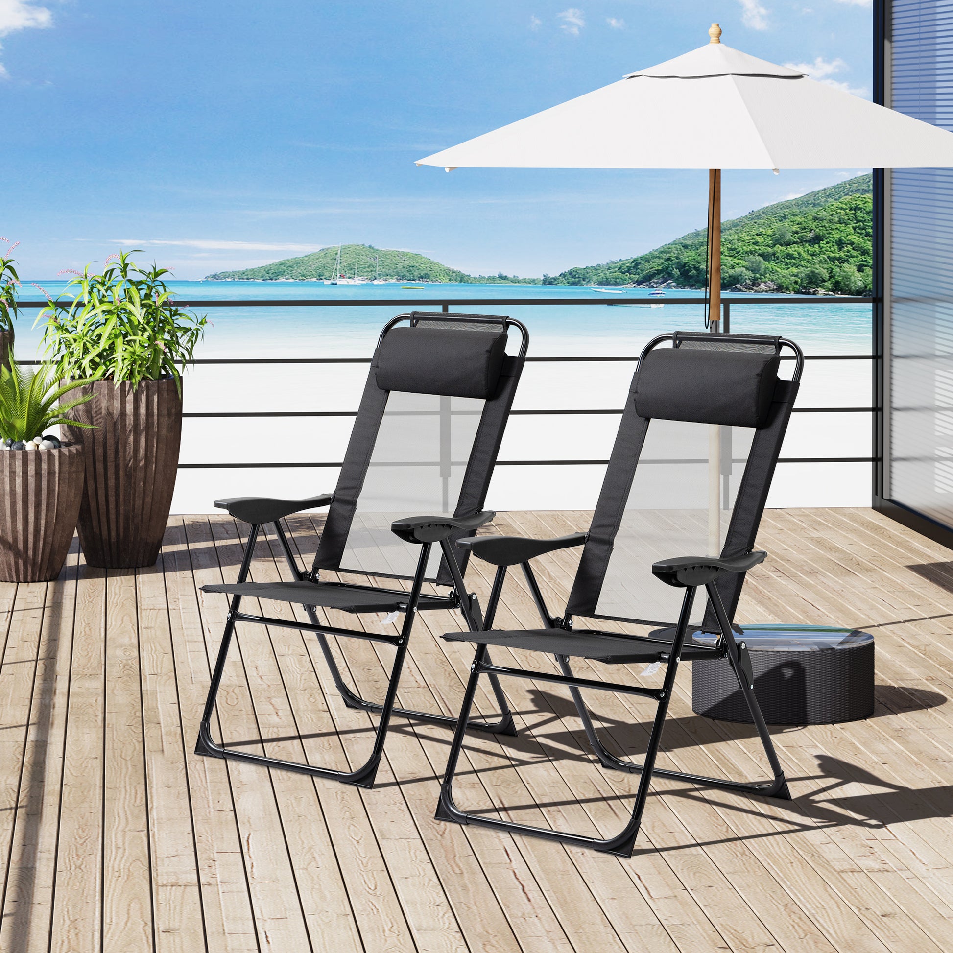 Two black mesh zero gravity chairs with adjustable headrests on a wooden deck
