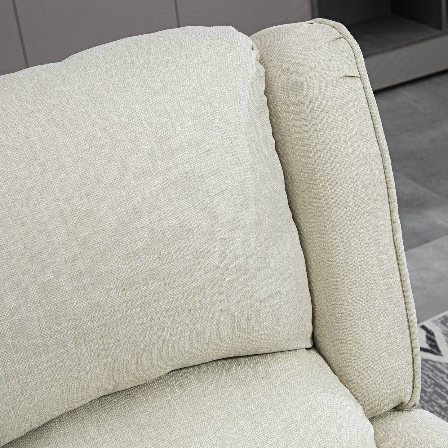 Closeup of a textured beige linen couch cushion and armrest offering a cozy feel