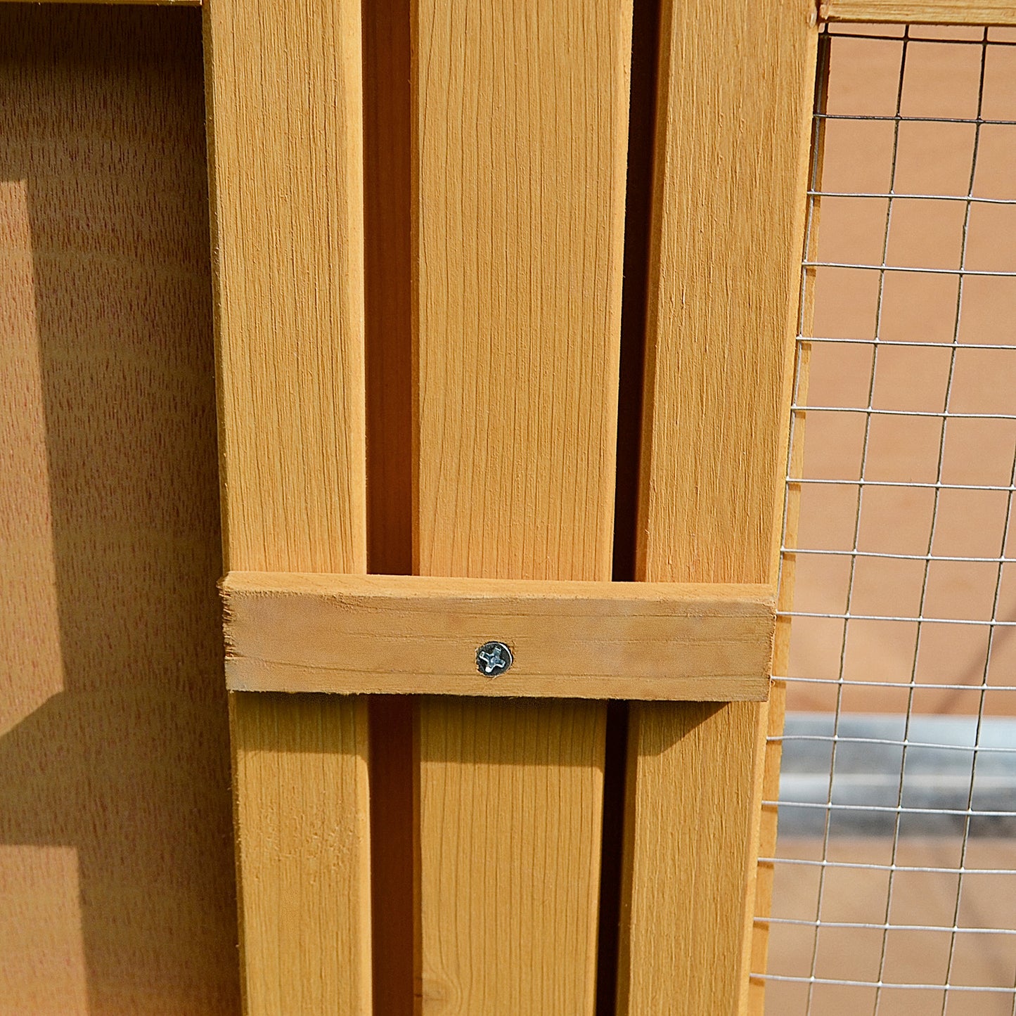 Wooden chicken coop panel with vertical slats and wire mesh