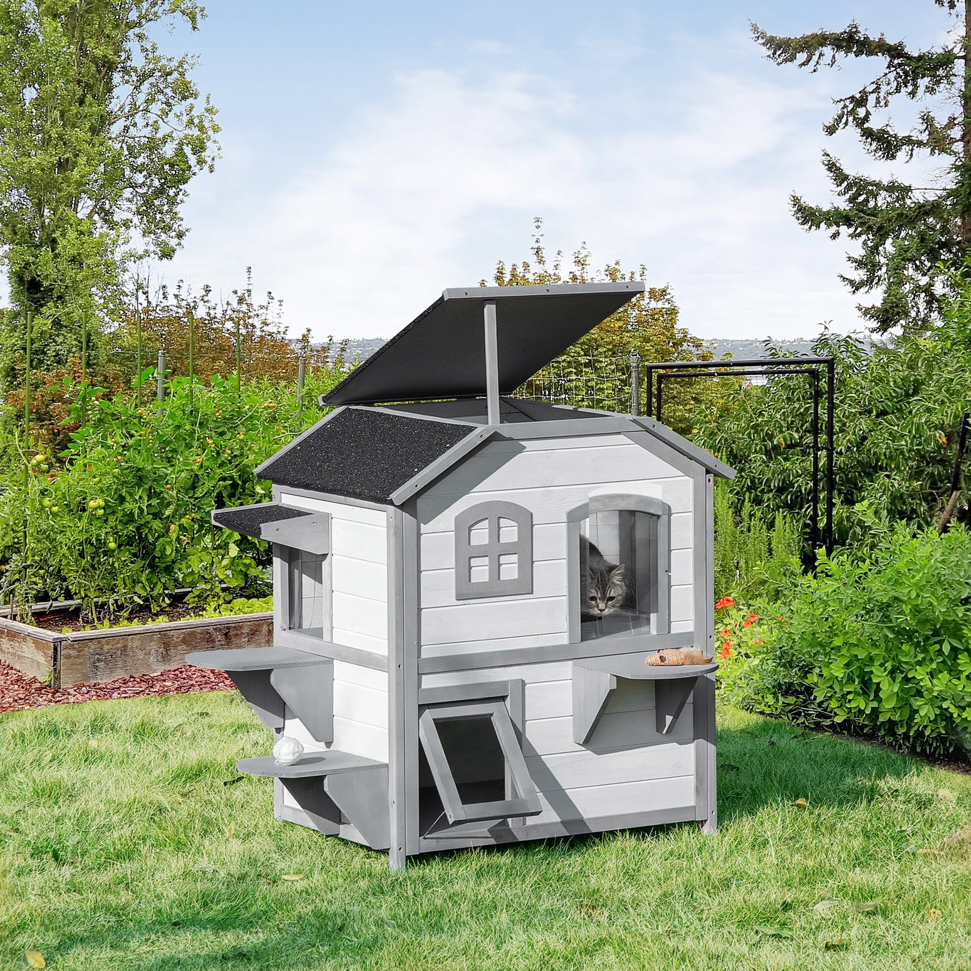 White and gray multilevel wooden cat house with lookout windows and perches ideal for outdoor pets