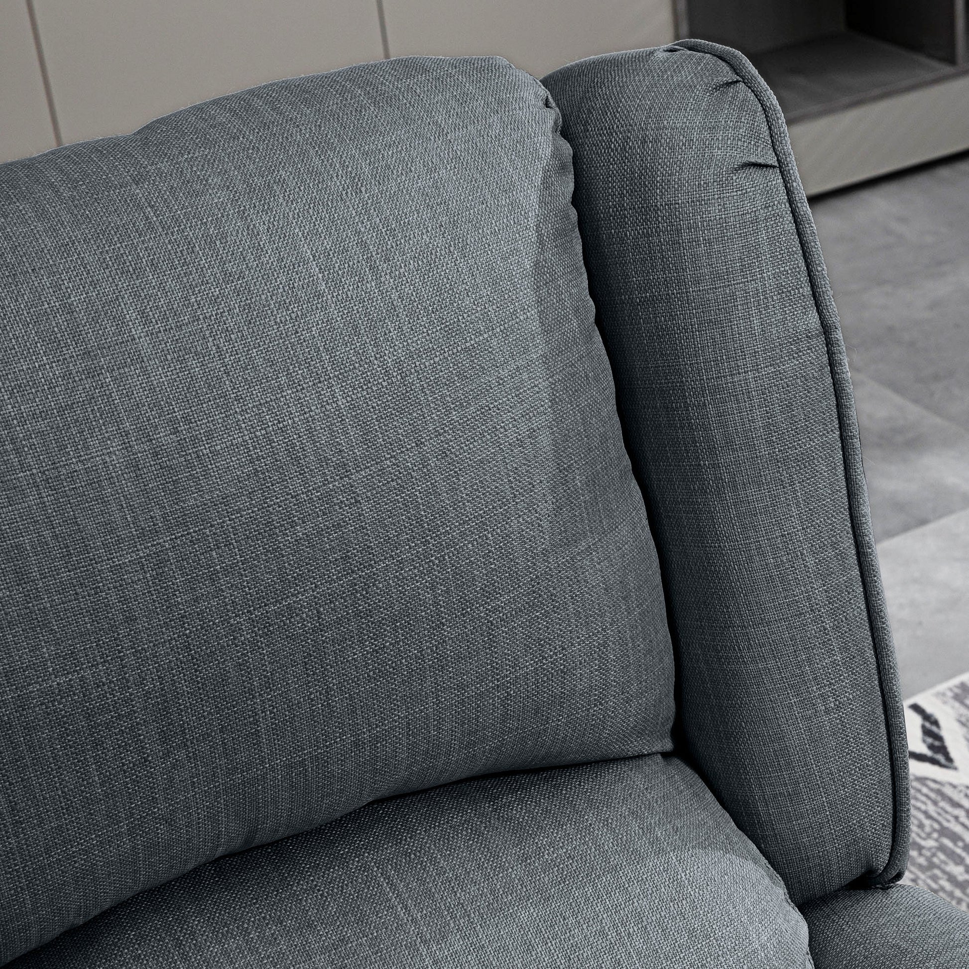 Closeup of plush dark grey linen sofa cushion with textured weave comfort