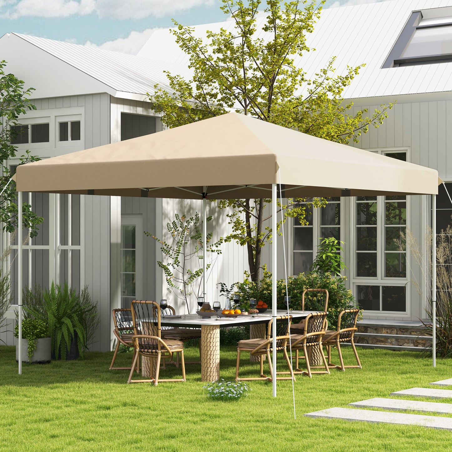 Beige outdoor canopy tent set up in a backyard with a table and chairs
